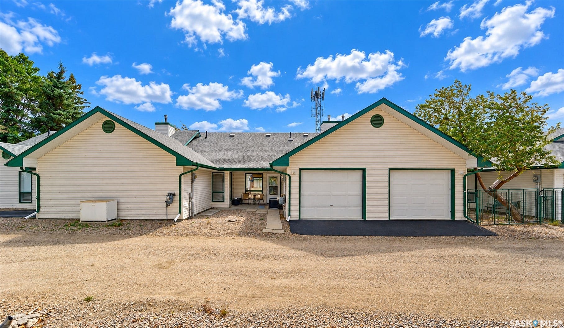 Cream-colored siding exterior with green trim accents