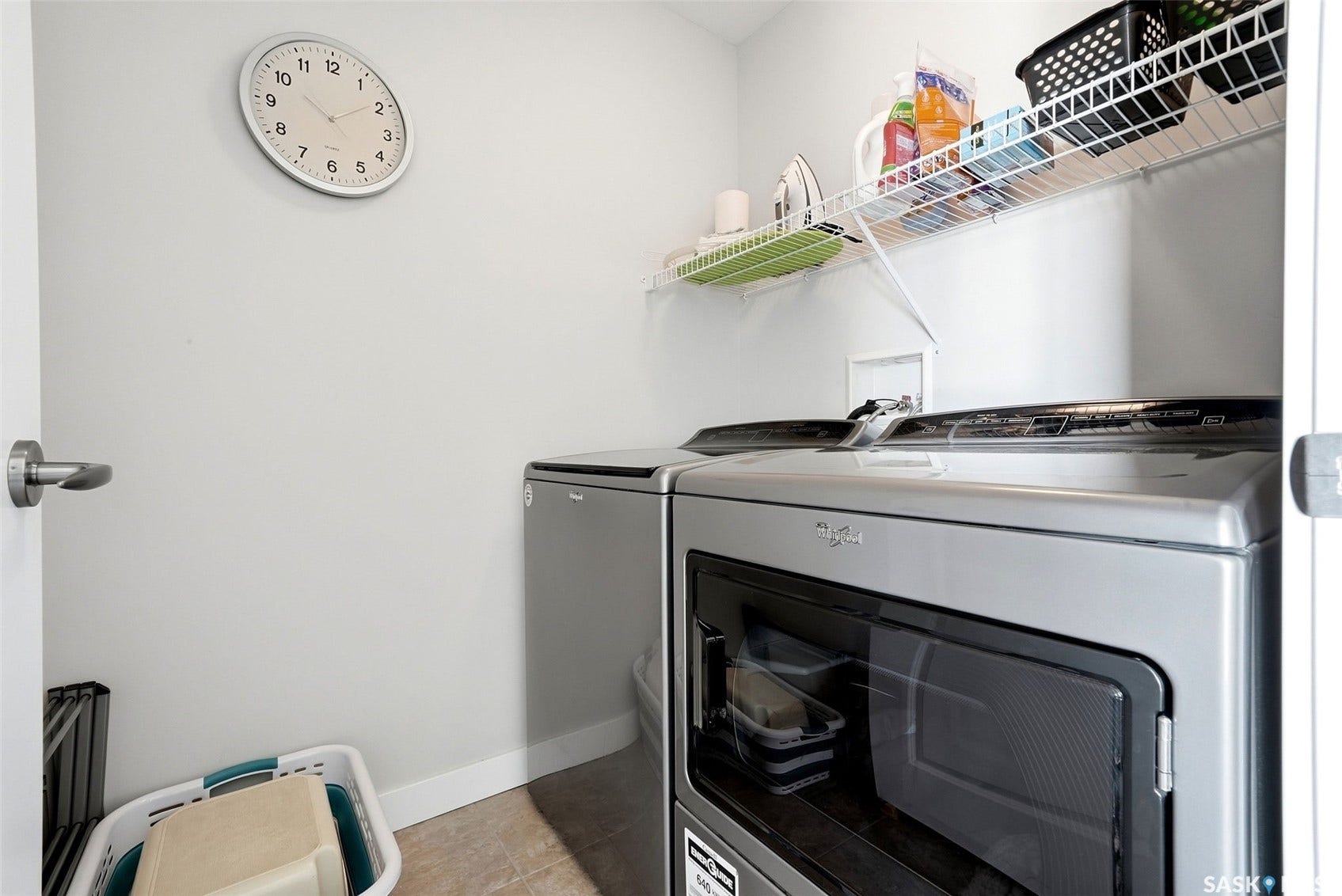 Laundry area featuring a wire shelf, tile flooring, and light gray walls