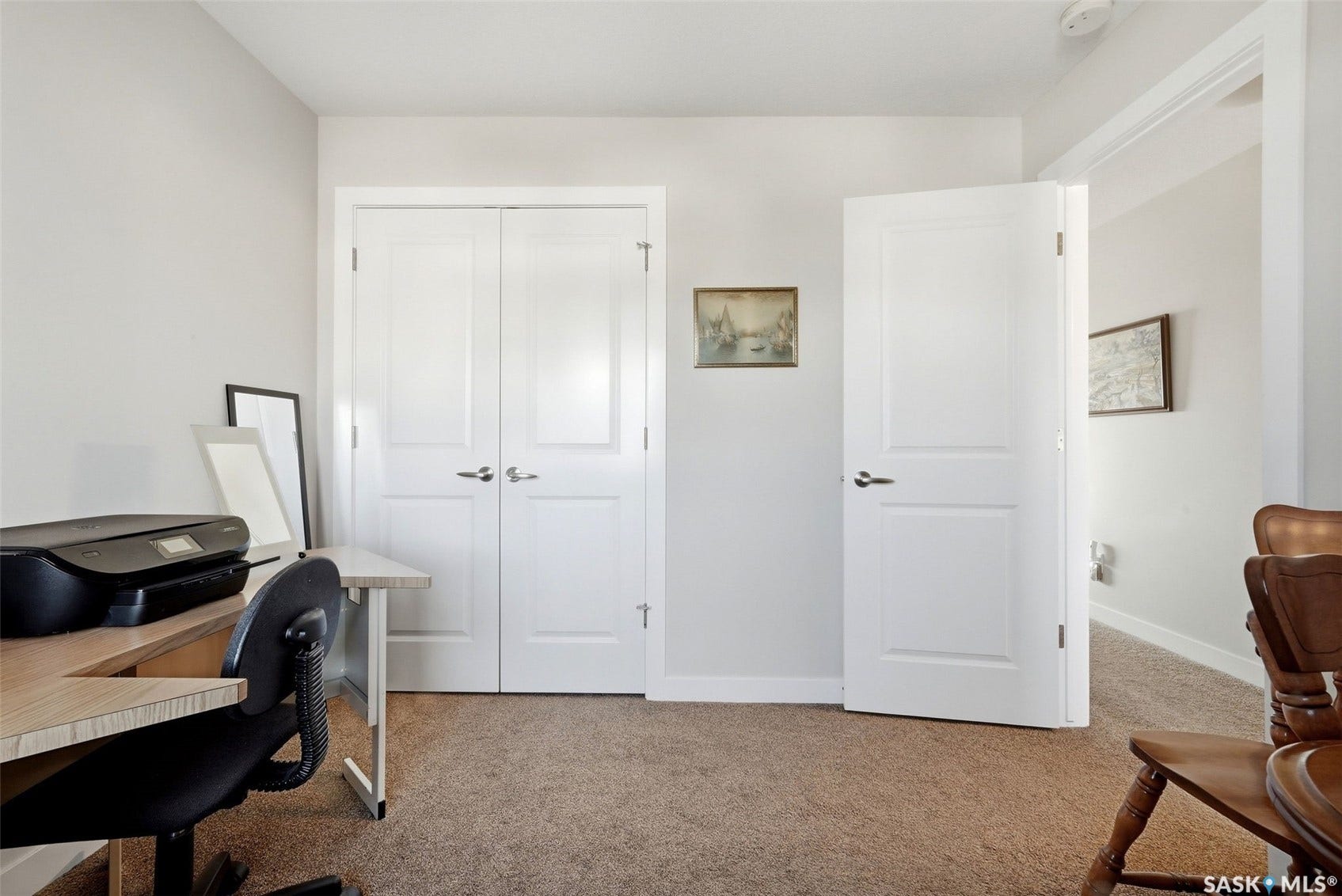 Neutral wall color with a contrasting white door frame and solid core door
