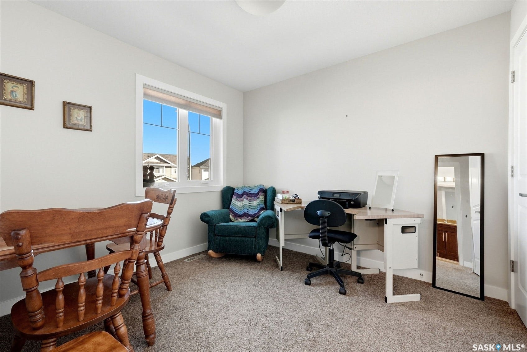 Bright room with neutral wall paint, carpet flooring, and a large window