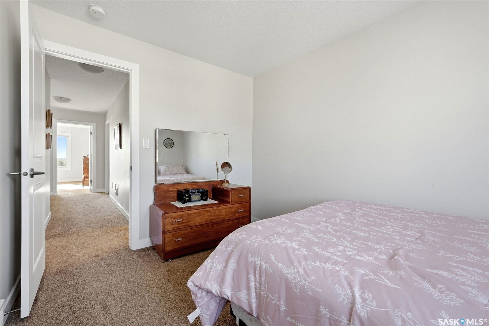 Neutral wall paint, carpeted flooring, and a standard door with lever handle