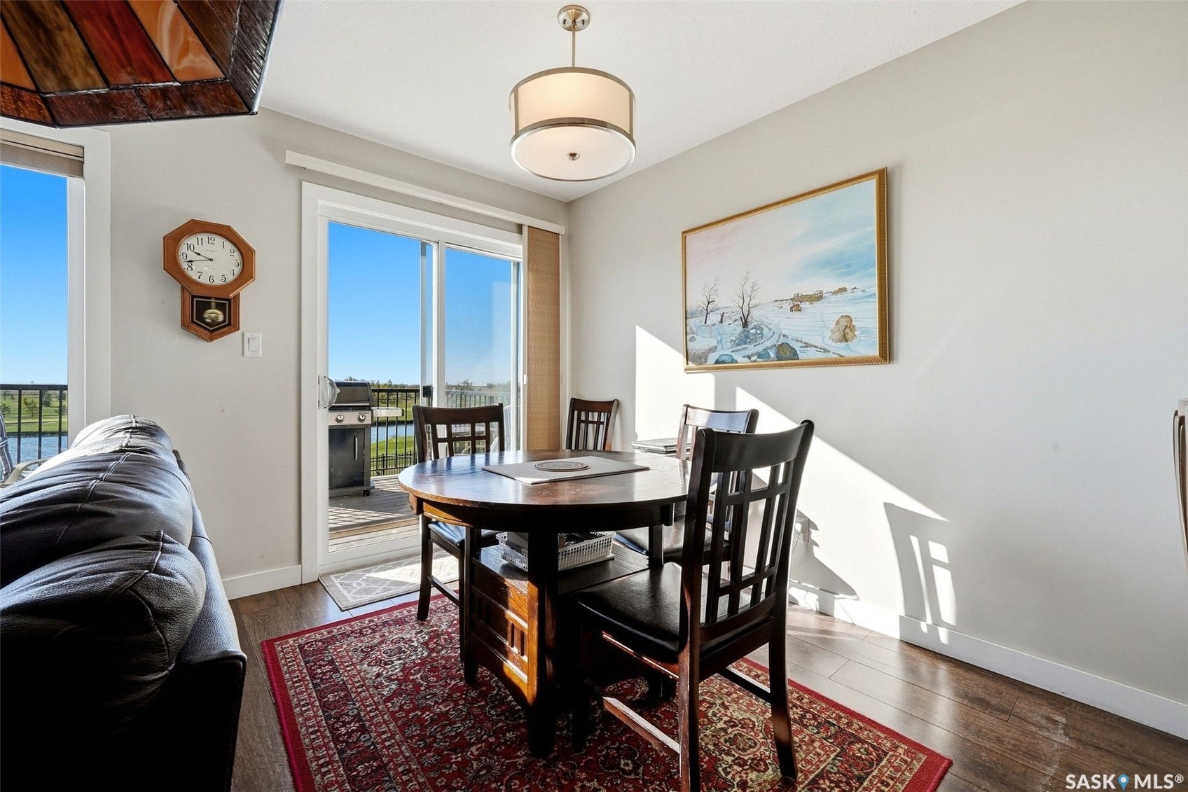 Wood-finish flooring, white walls, and a sliding glass door to an outdoor deck
