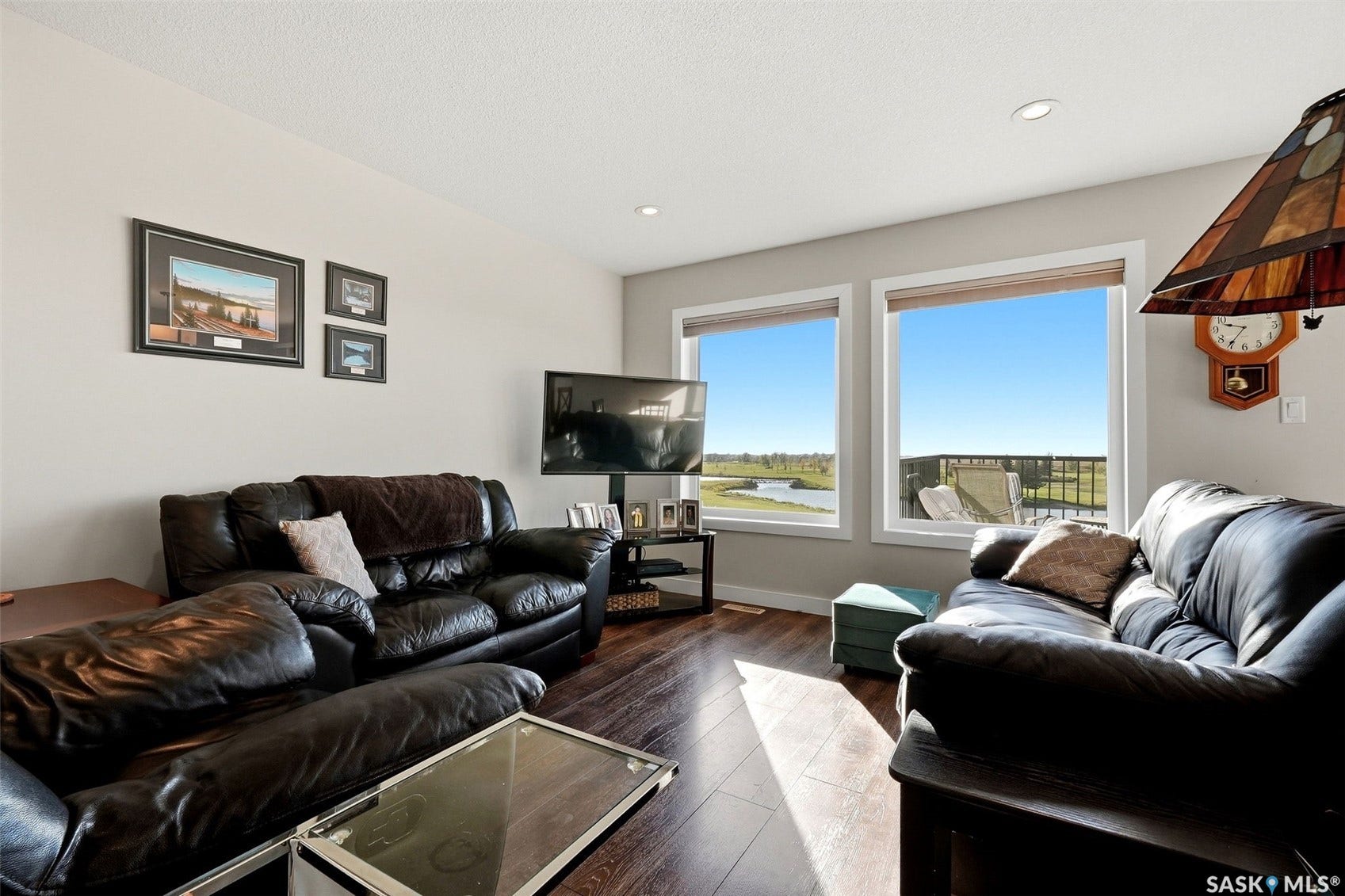 Wood-finish flooring throughout, recessed ceiling lighting, and large windows