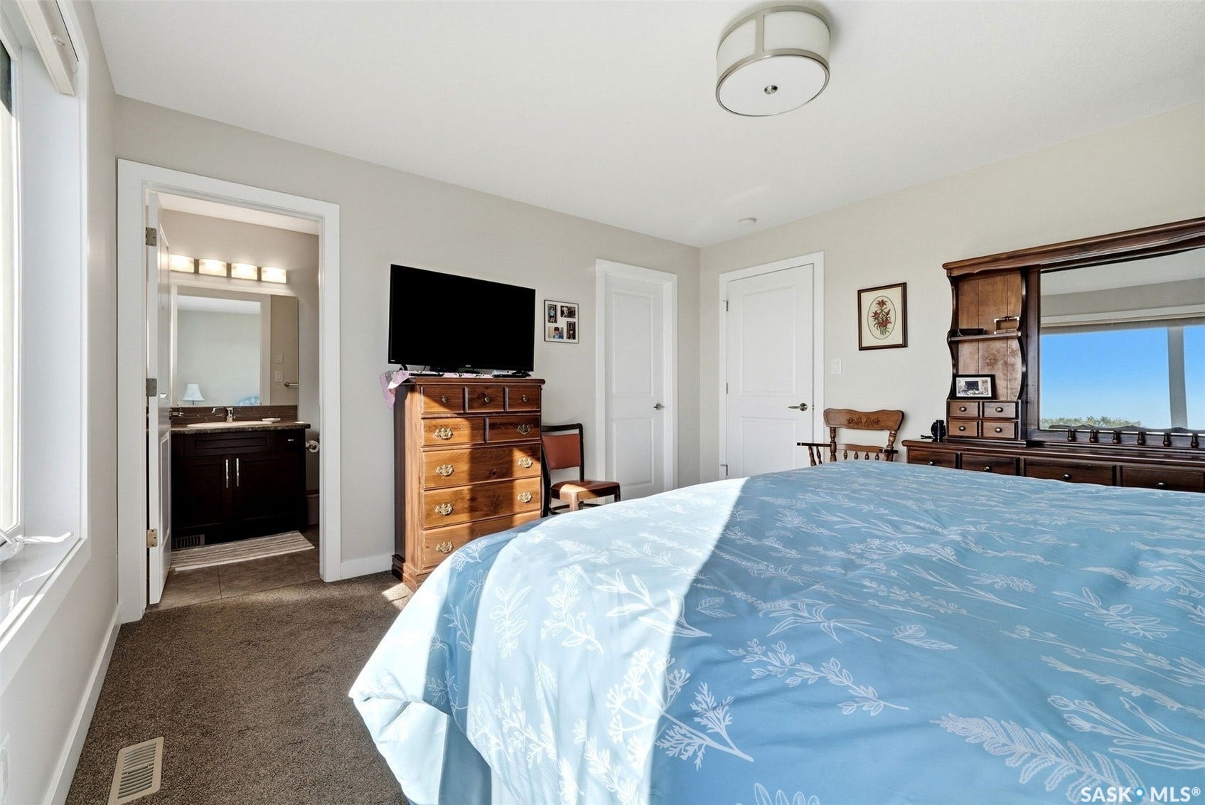 Plush carpeted flooring, white trim, and a semi-flush mount ceiling light fixture