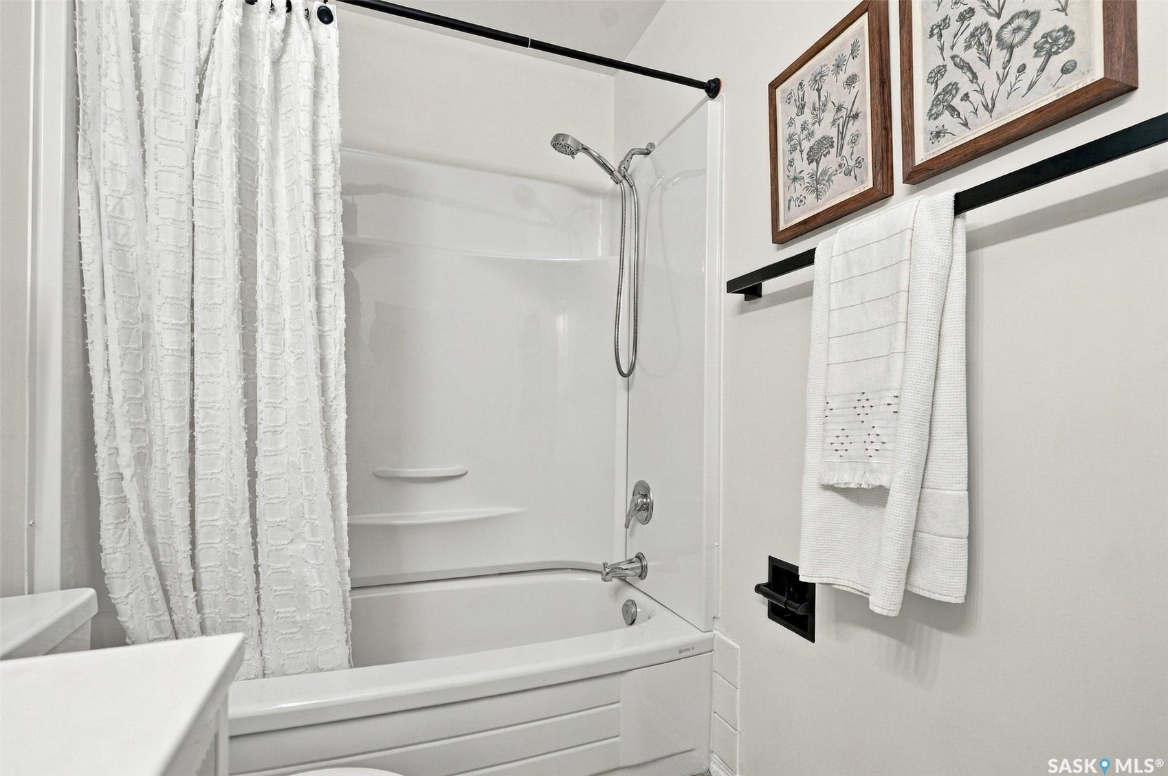 Tub and shower combination with chrome fixtures and integrated shelving