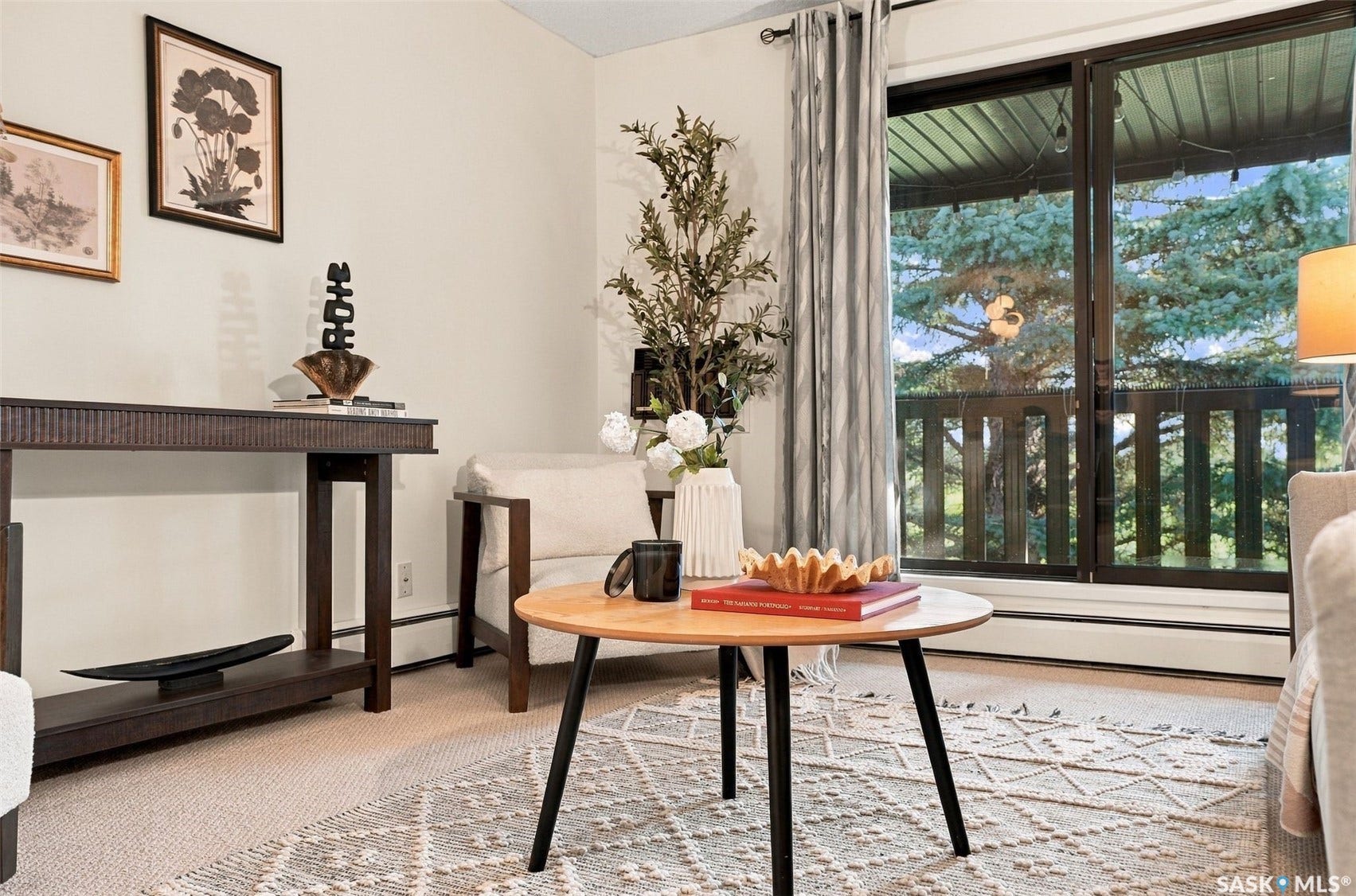 Wall-to-wall carpeting with a sliding glass door leading to a balcony with a wooden railing