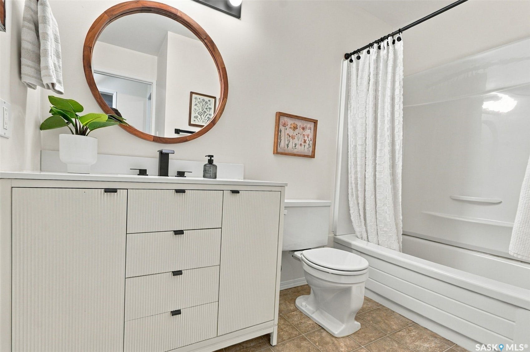 Integrated vanity with textured cabinetry and matte black hardware