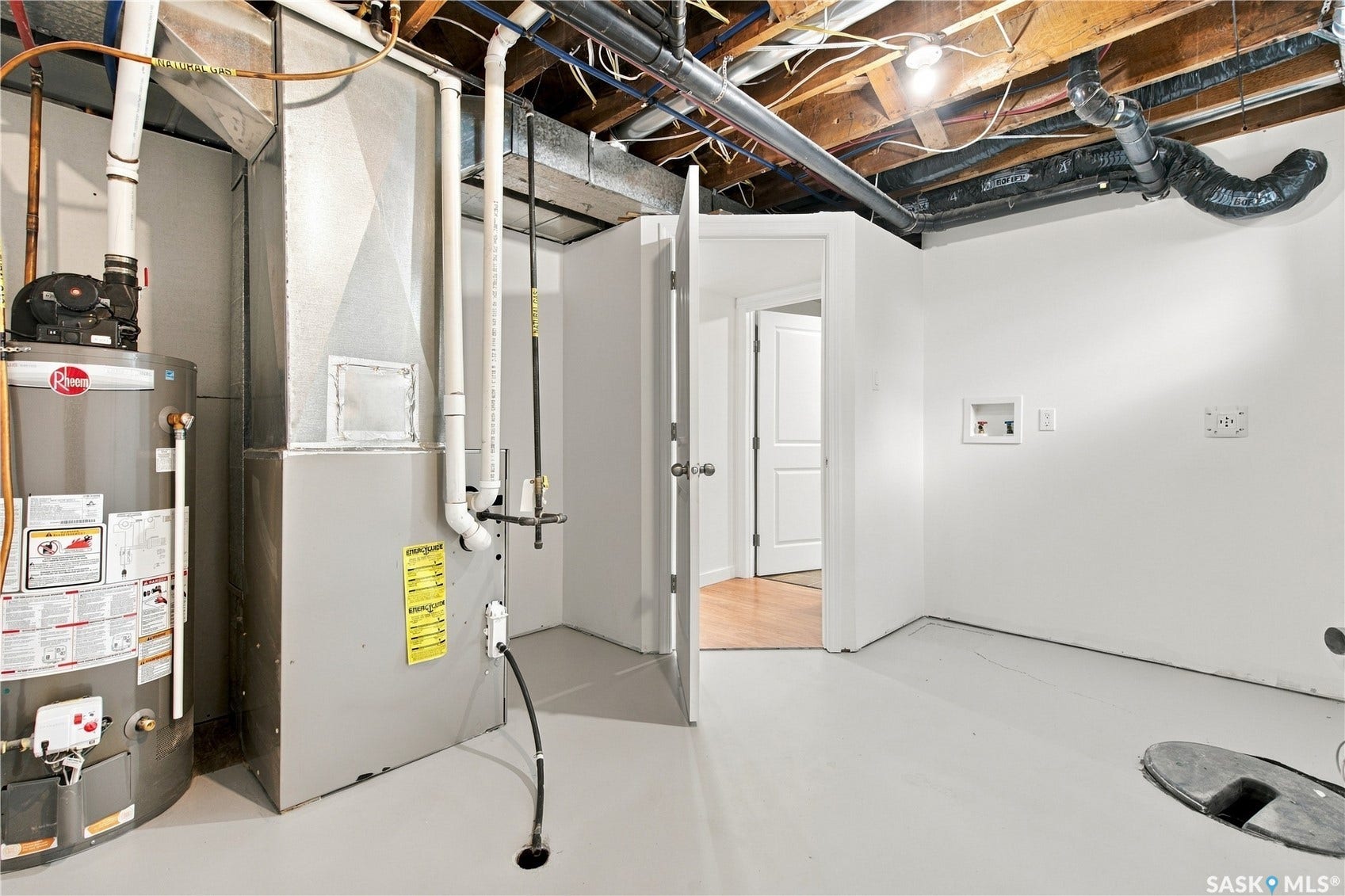 Utility area featuring a water heater, furnace, and visible laundry hookups