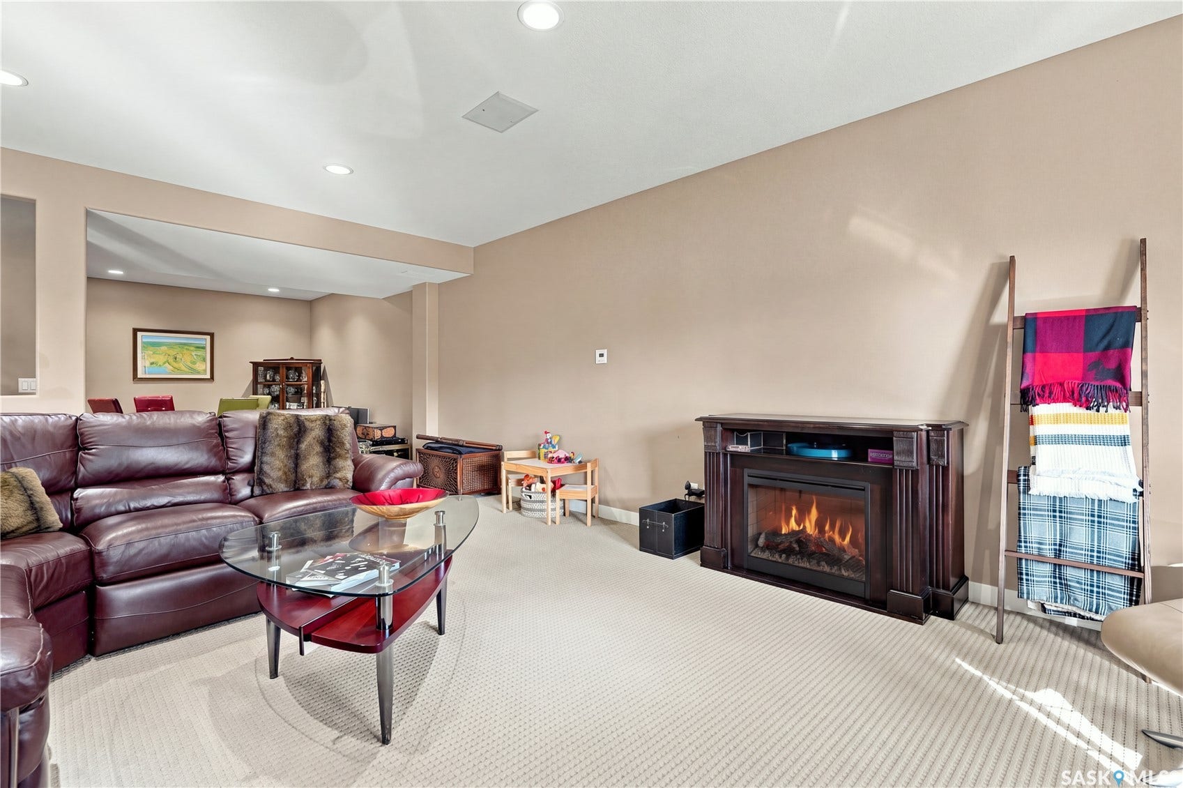 lower level living room area with recessed pot lighting and ceiling speakers