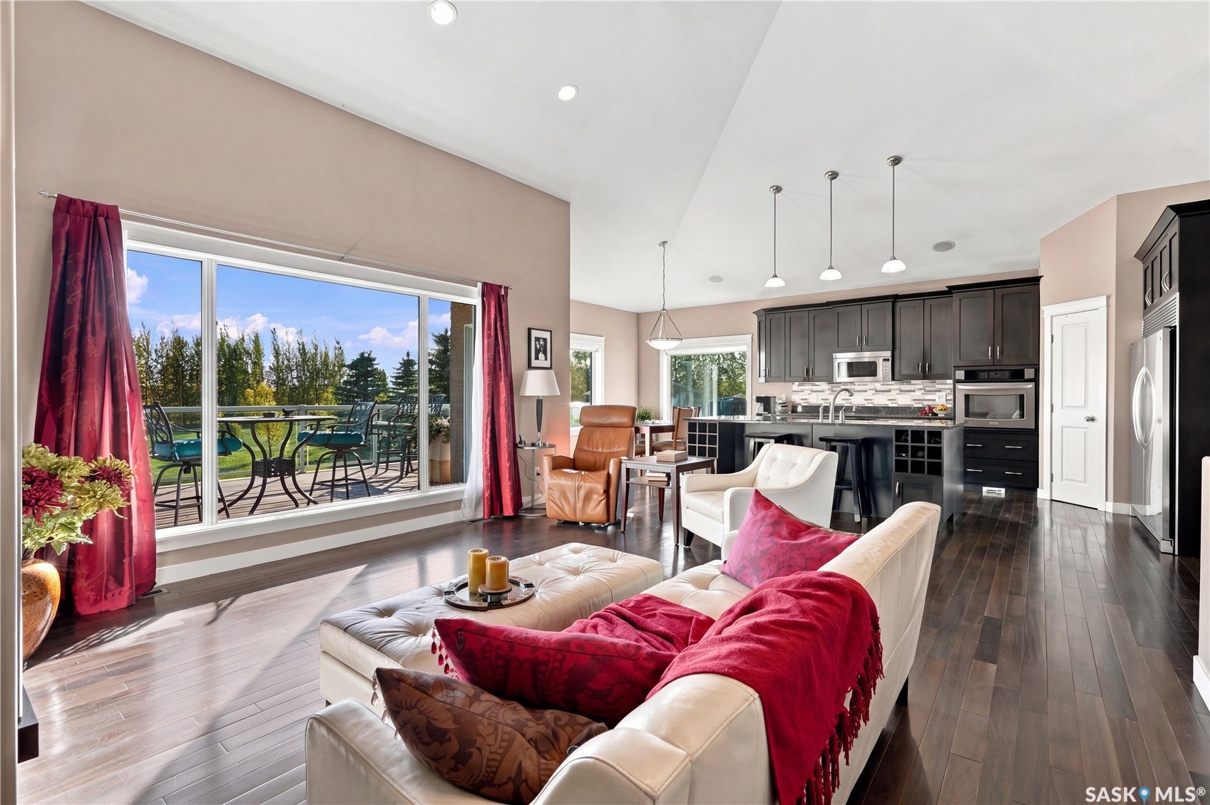 spacious living/kitchen dining area with large  beautiful windows providing tons of southern exposure the gorgeous and and emitting warm sunlight for our winters