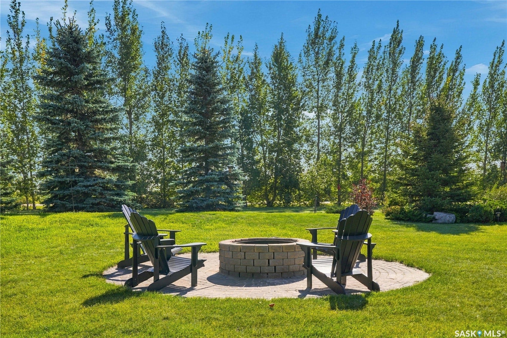 fire pit area and fully manicured yard and trees