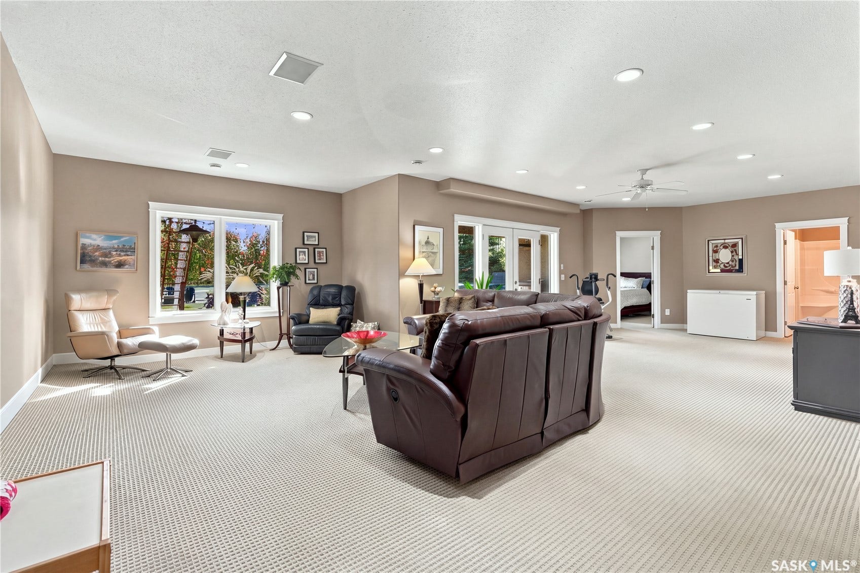 lower level living room area with wired sound and ceiling speakers