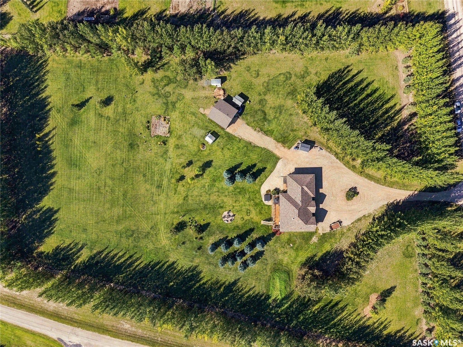 absolutely stunning package including the 1500 ft. walkout bungalow with triple attached garage and a large detached shop with 9 foot overhead door as well as two sheds  and plenty of extra space for more garden area or whatever else you would like to add