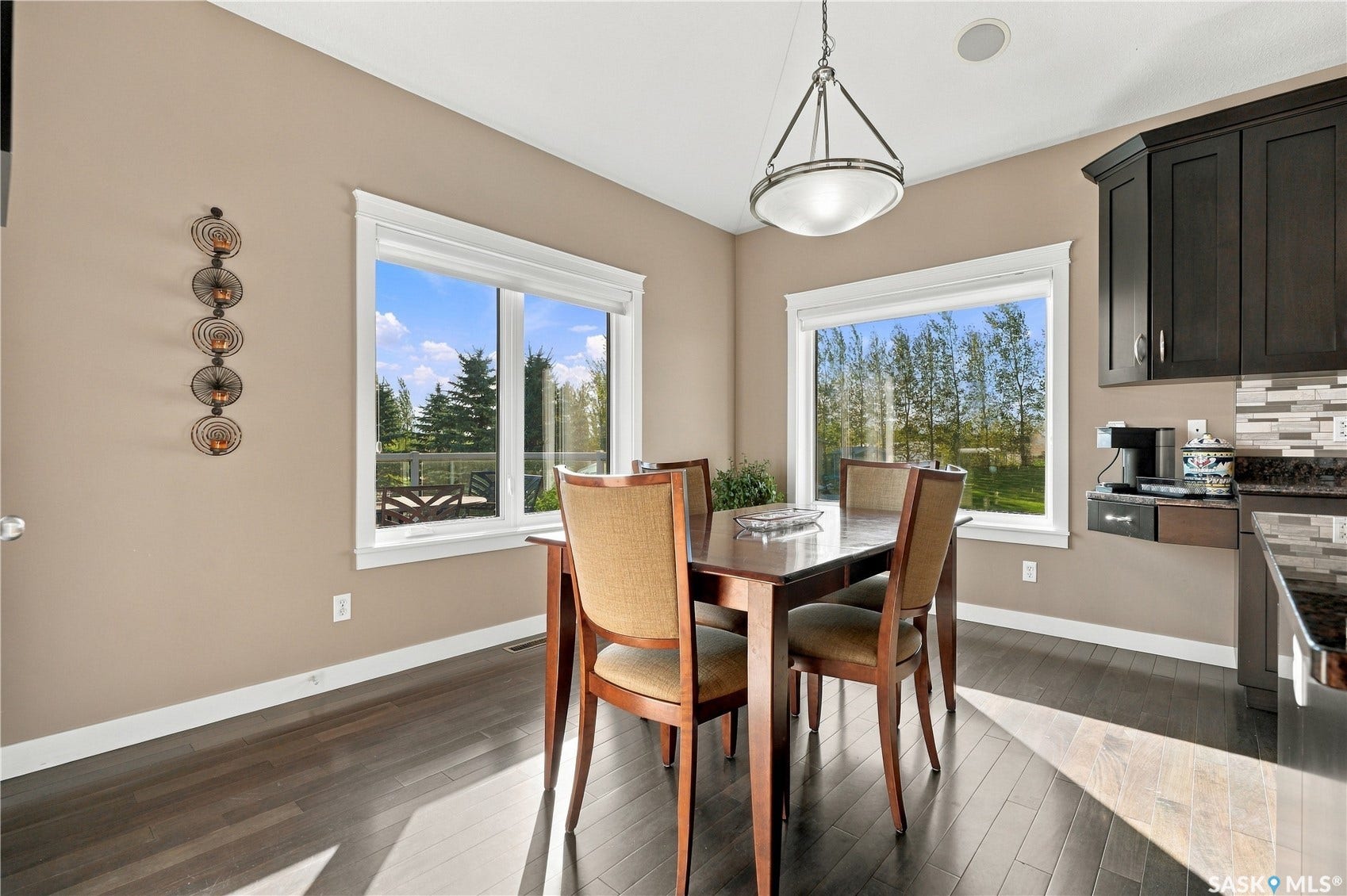 dining area features a door to the upper level deck and two large picture windows facing south and west to ward the yard and extra detached shop
