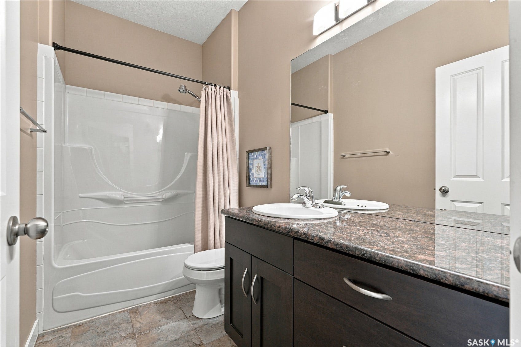 main floor bathroom located beside two of the upper level bedrooms