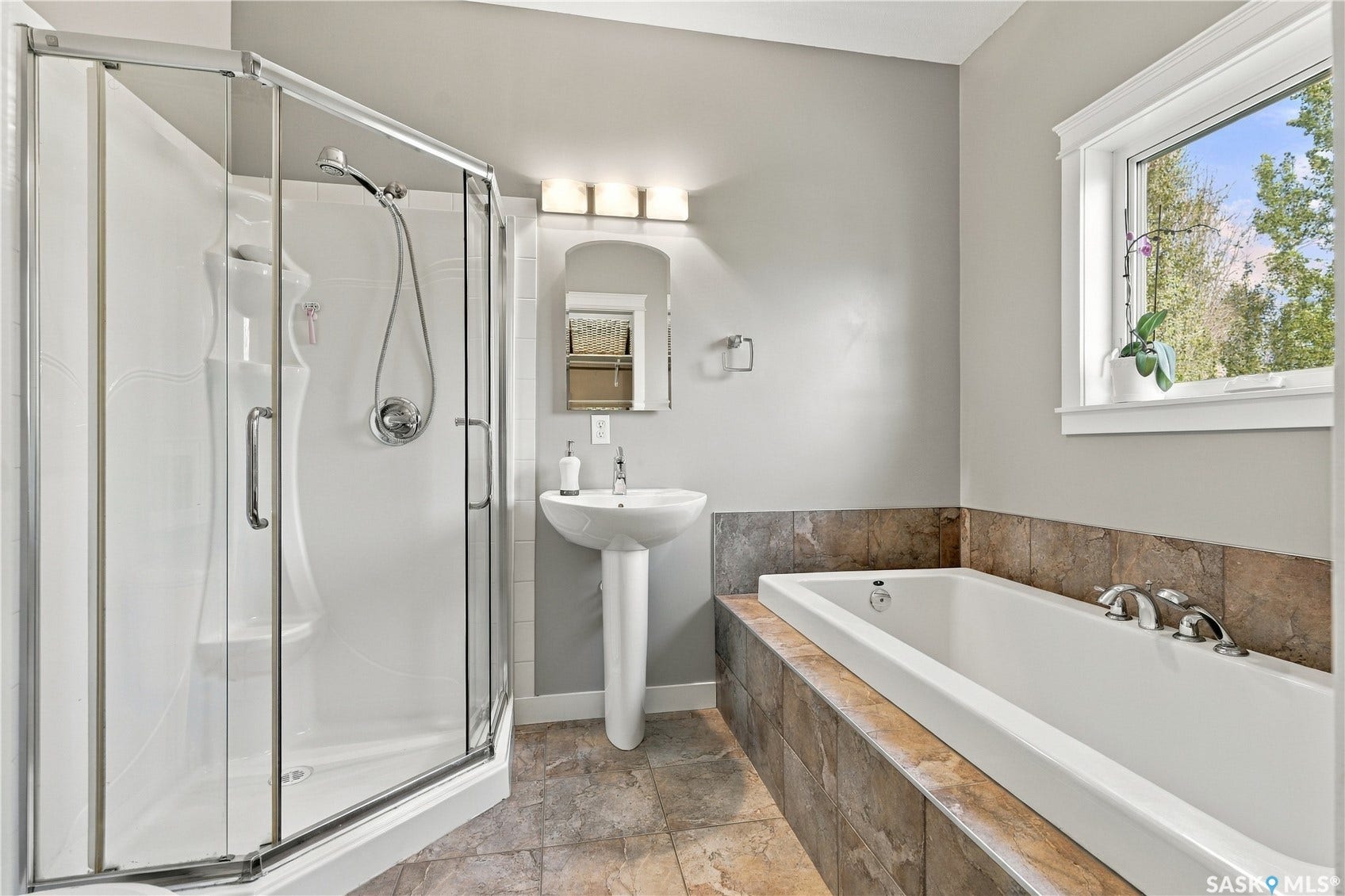 ensuite bathroom  with separate tub and shower off of primary bedroom