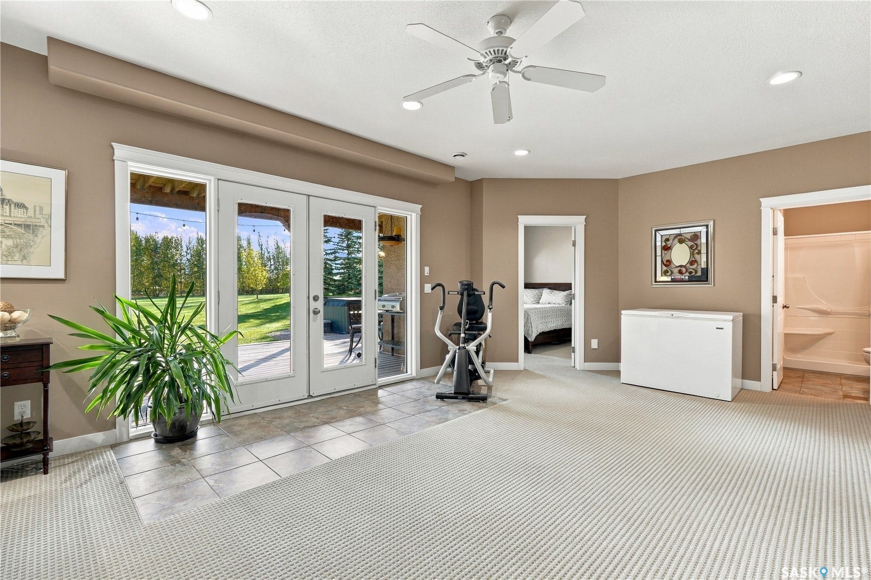 walk out doors to the lower level deck and hot tub next to the 4 lower level bedroom and bathroom