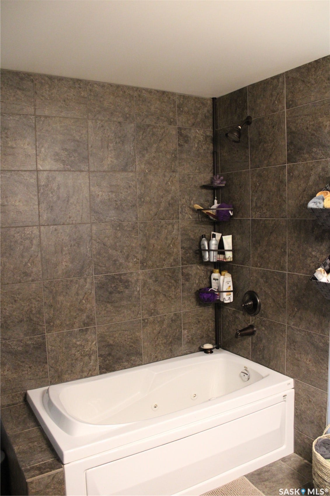 Bathroom with tiled shower / bath combo and tile patterned floors