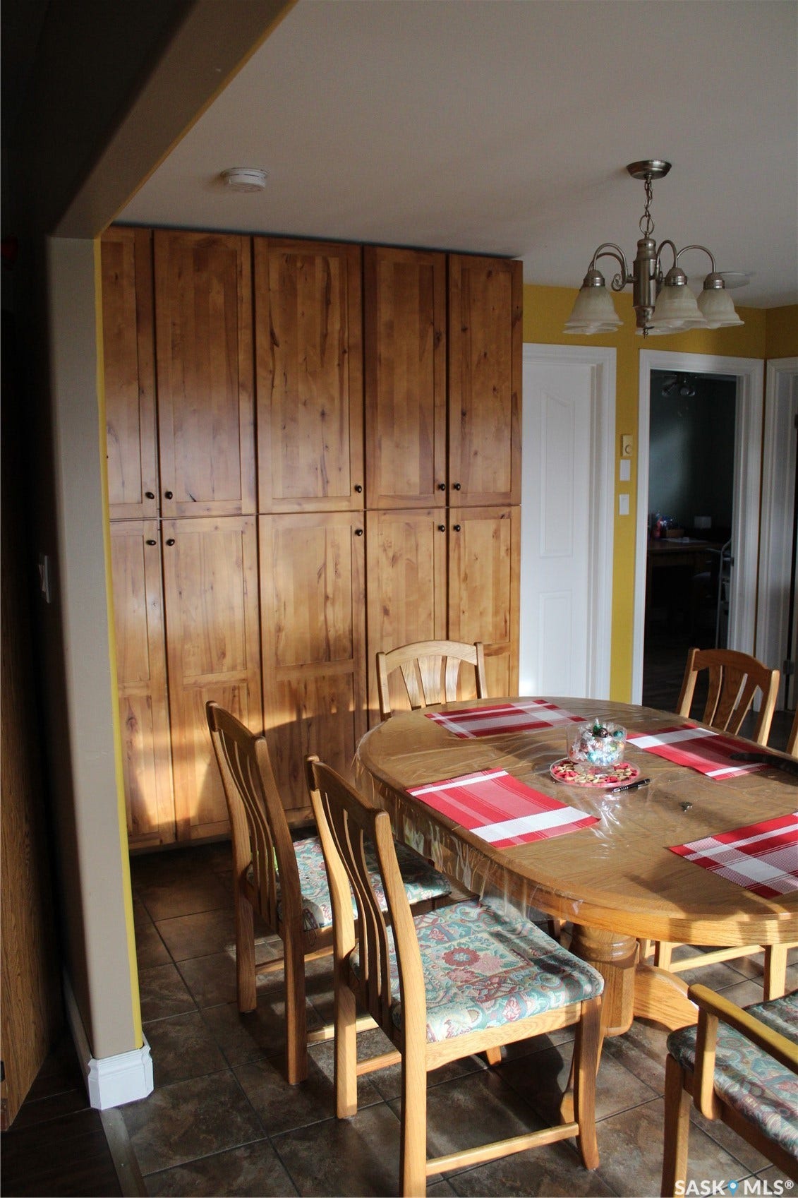 Tiled dining area featuring an inviting chandelier