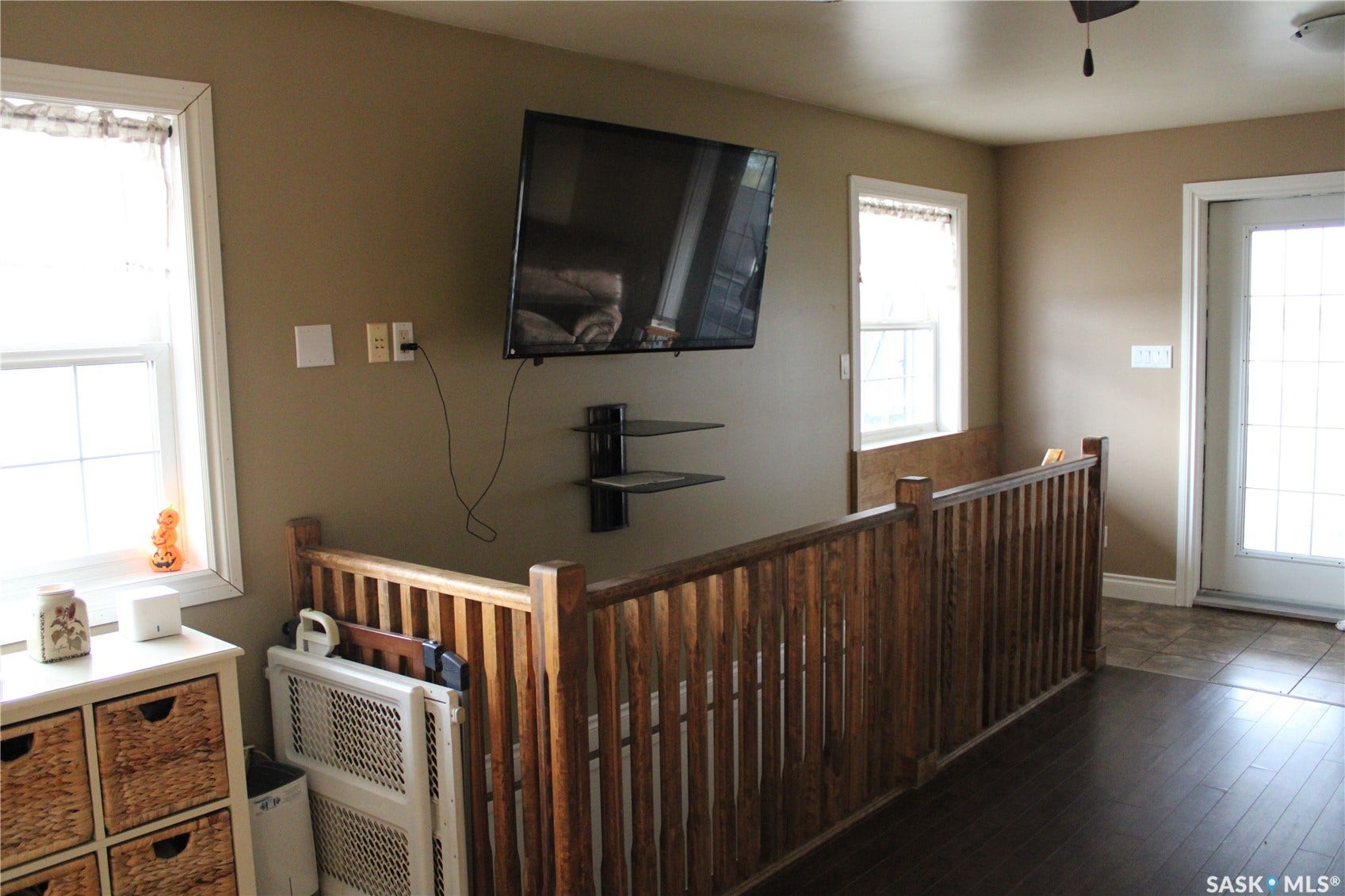 Living room featuring a wealth of natural light and dark hardwood / wood-style flooring