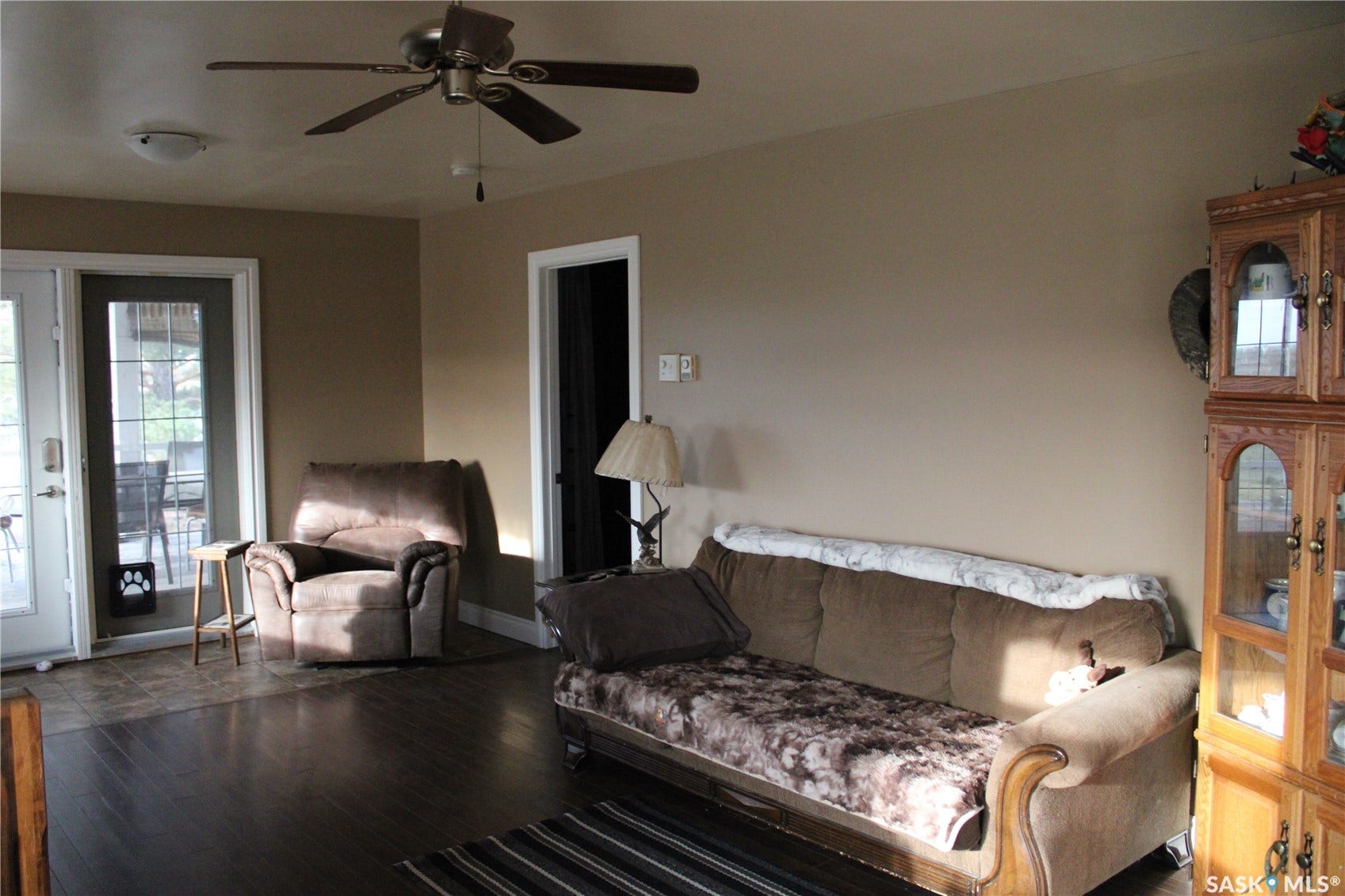 Living room with hardwood / wood-style floors and ceiling fan