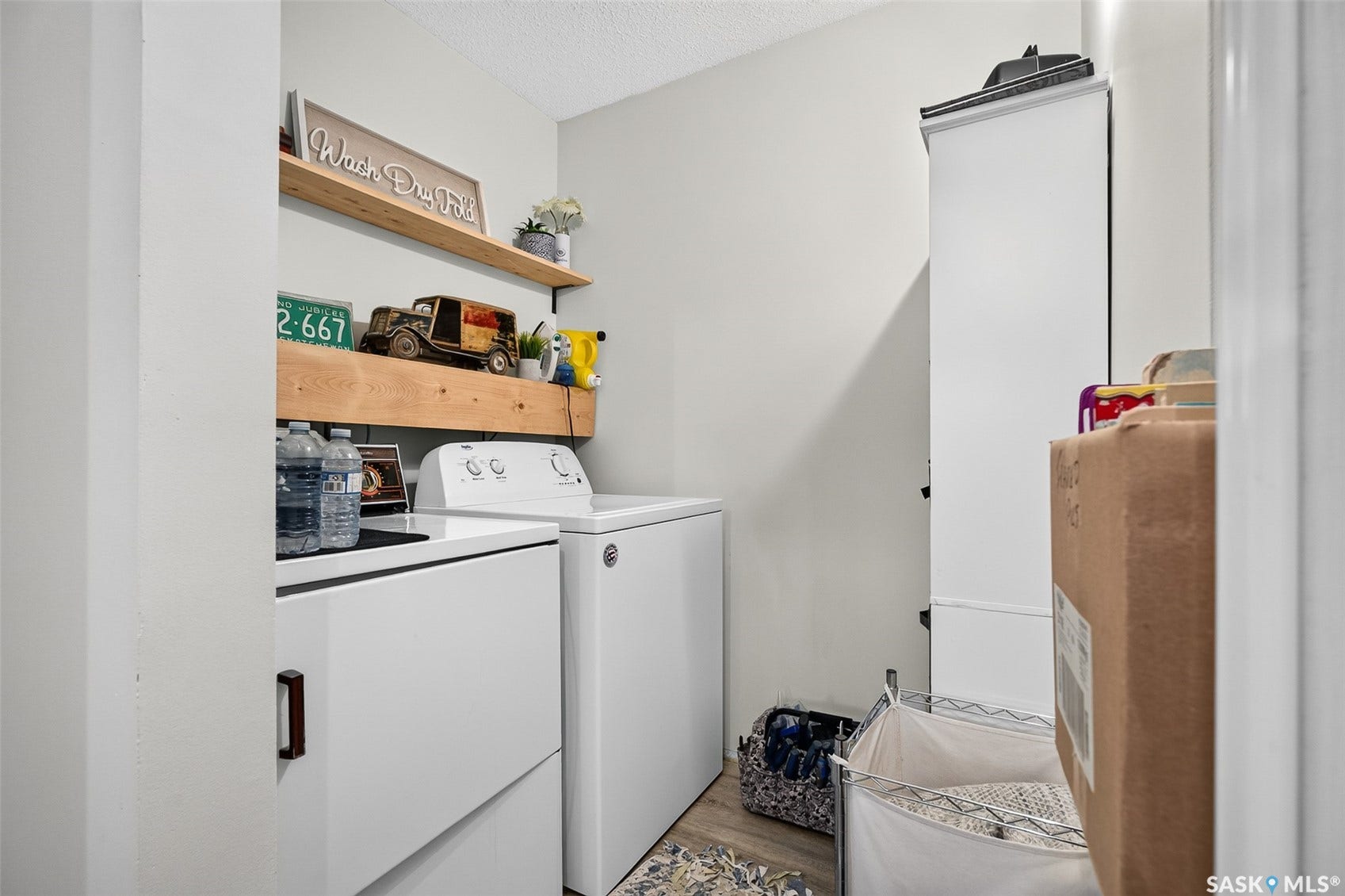 Built-in white cabinetry, wood-finish shelving, and light-toned walls