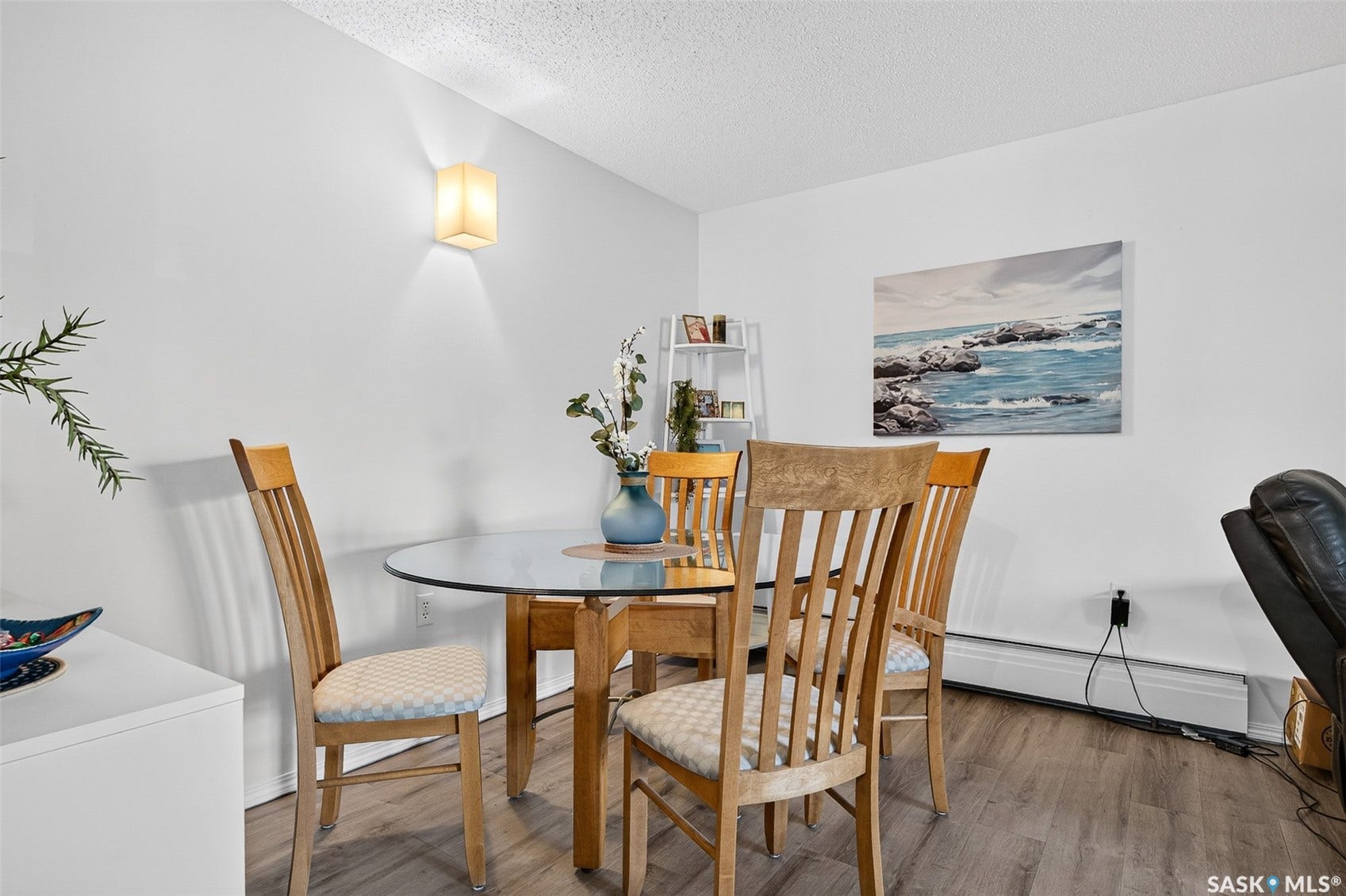 Wood-finish flooring with white wall finishes and a ceiling-mounted light fixture