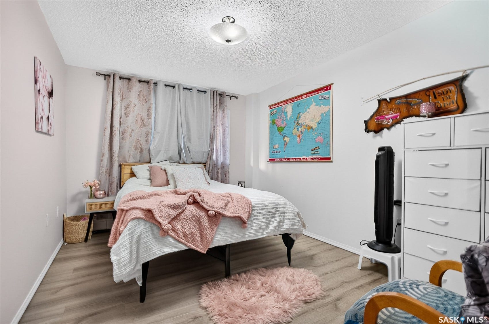 Wood-finish flooring, recessed lighting, and window treatments