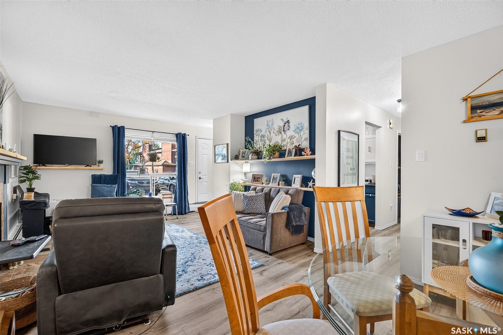 Open-concept living area with wood-finish flooring