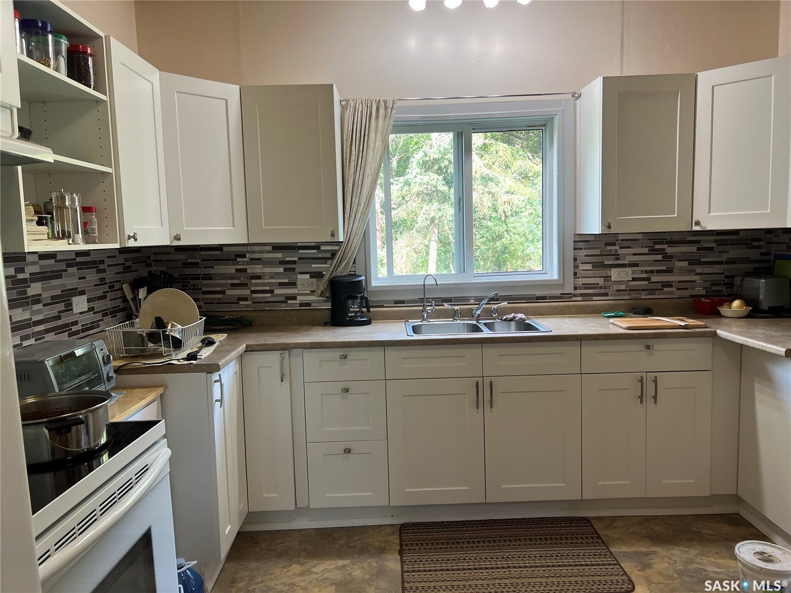 White shaker-style cabinetry with matte silver hardware