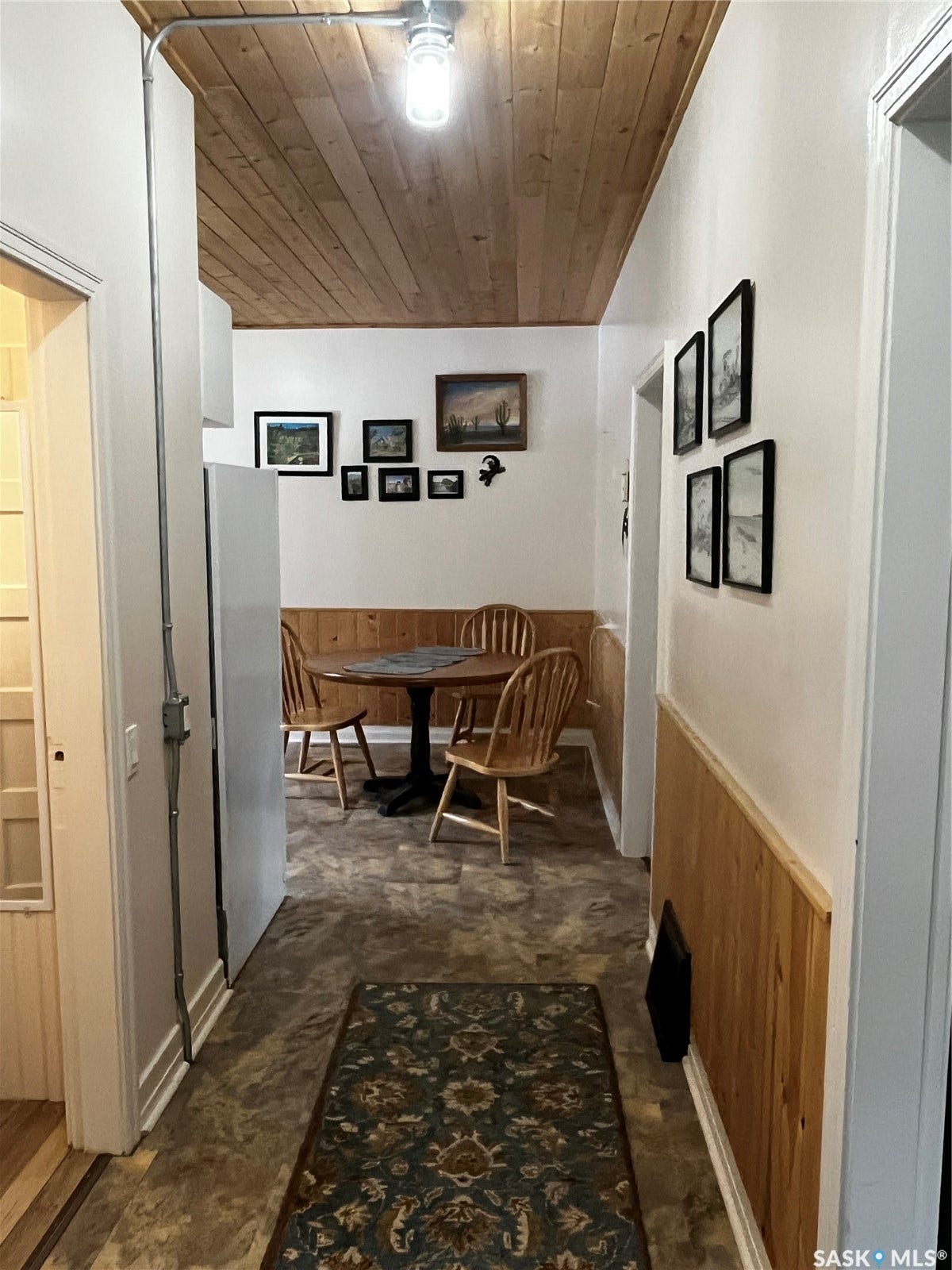 Wood-finish ceiling panels, wainscoting, and durable flooring in this versatile interior space