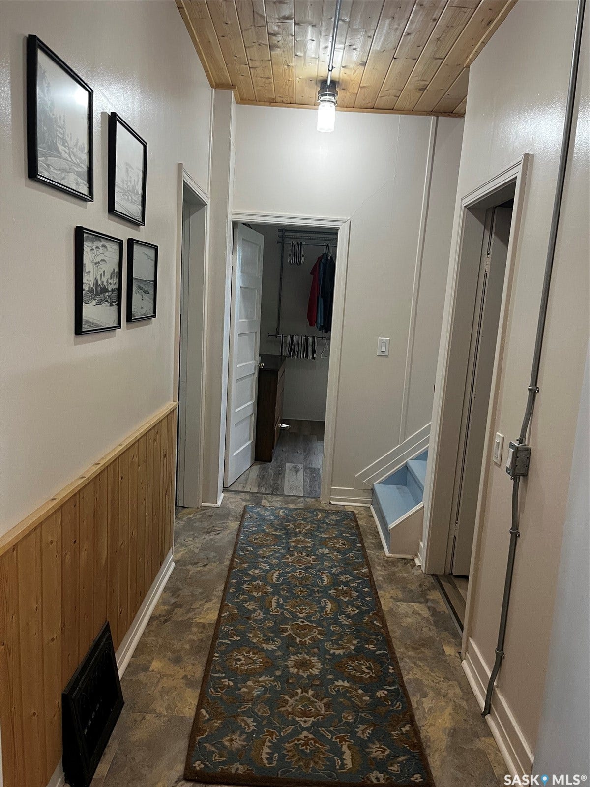 Wood-panel accent wall and wood-finish ceiling