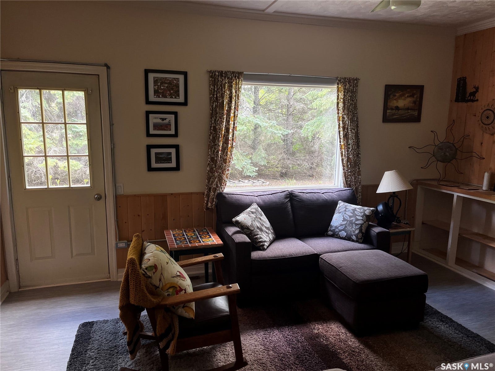 Wood-finish flooring, wood paneling, built-in shelving, glass-paned door