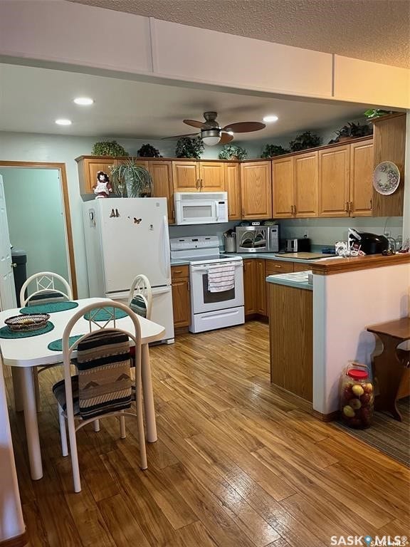 Wood-finish flooring throughout the kitchen and dining area