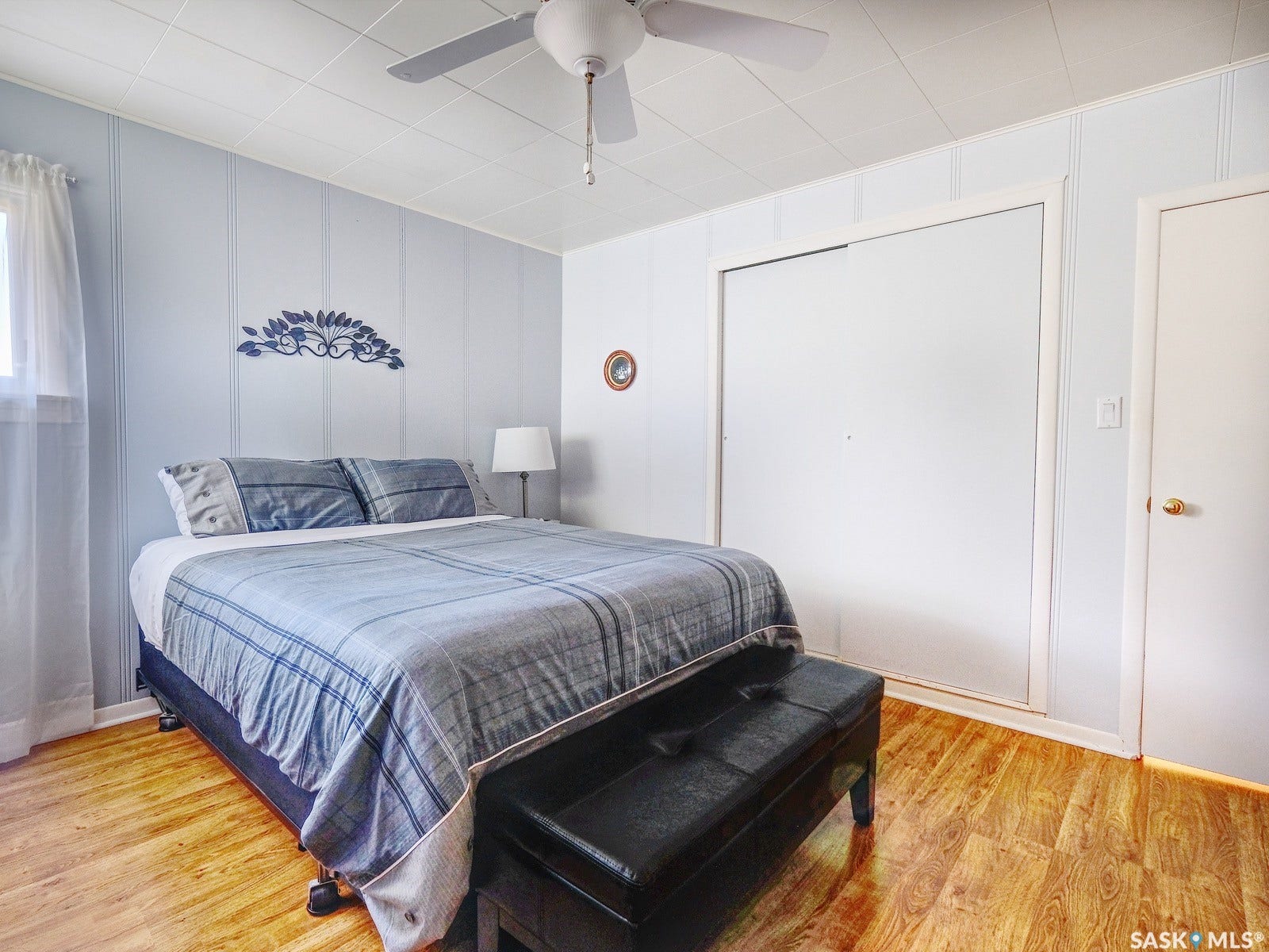 Wood-finish flooring with light-toned wall paneling