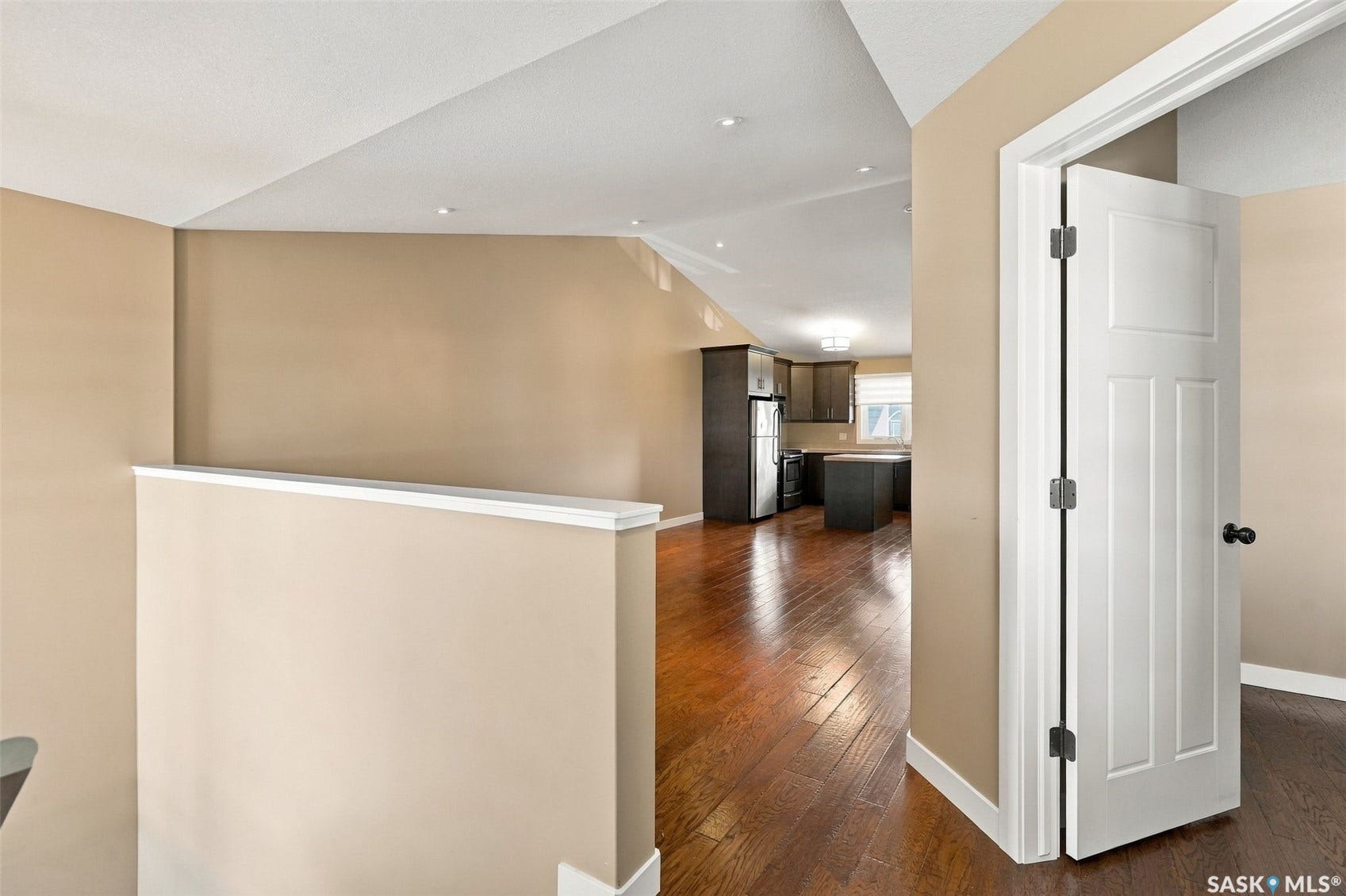 Hardwood-style flooring throughout, recessed lighting, and a neutral wall palette