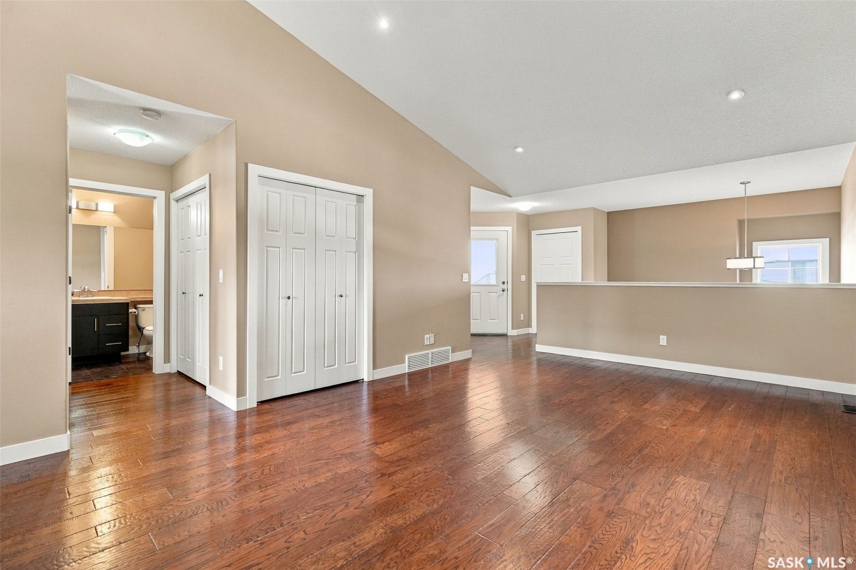 Hardwood-finish flooring throughout, recessed ceiling lighting, and a neutral wall palette