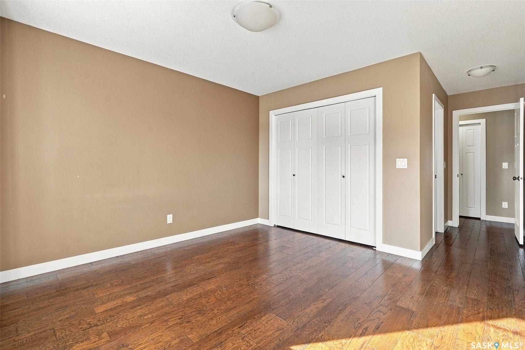 Primary Bedroom with Engineered hardwood flooring