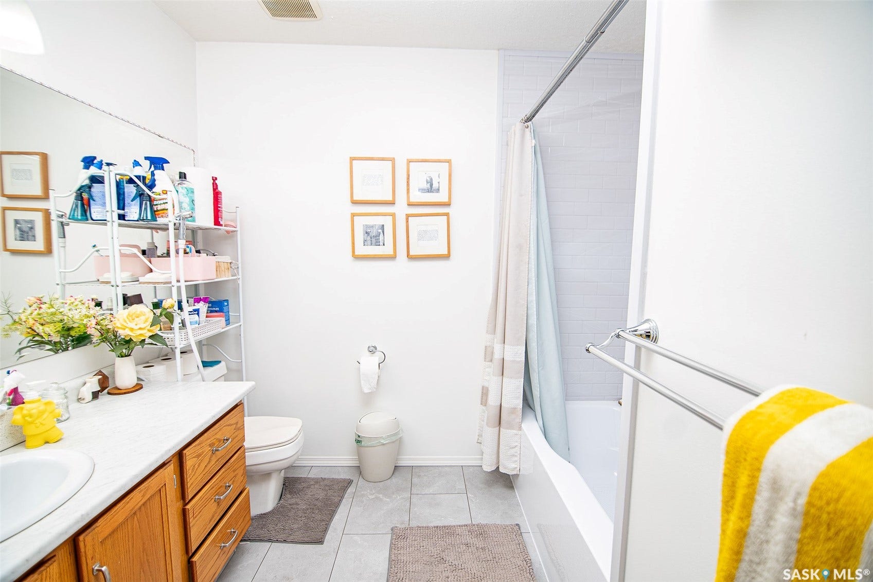 Bathroom featuring a built-in vanity with wood-finish cabinetry, a white countertop, and an integrated sink