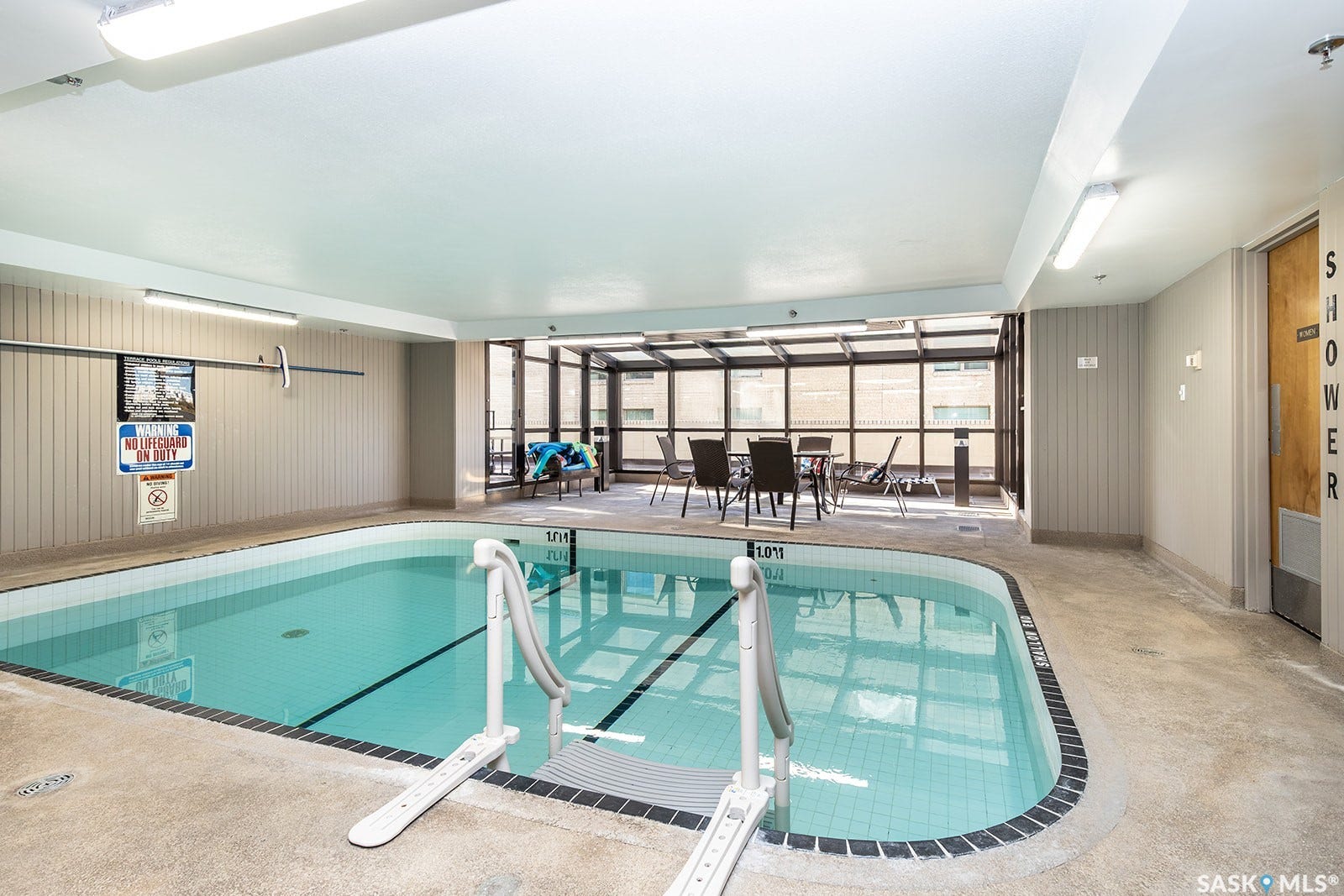Indoor salt-water swimming pool with tile finish and integrated accessibility lift