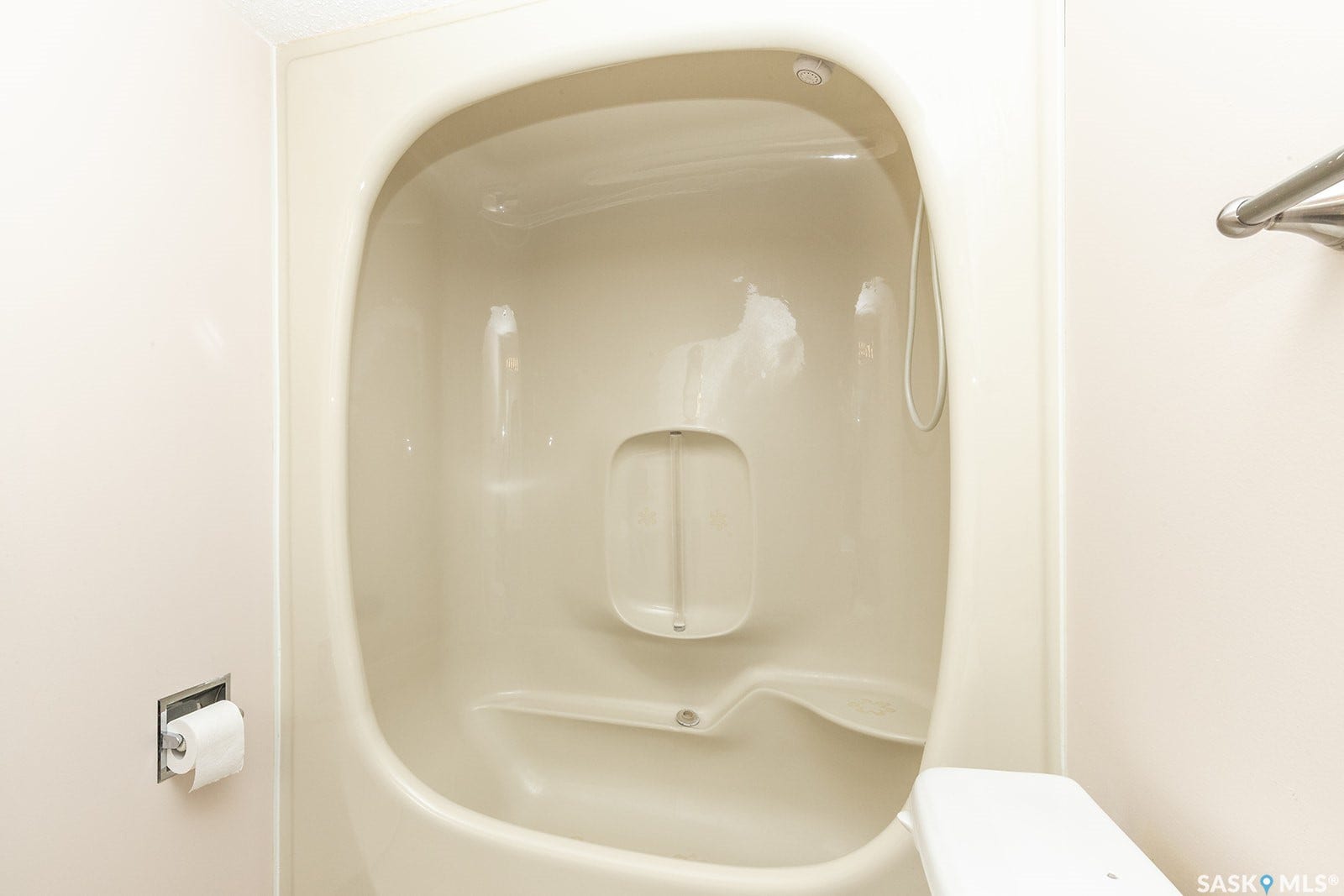 Integrated shower stall with built-in seating and grab bar