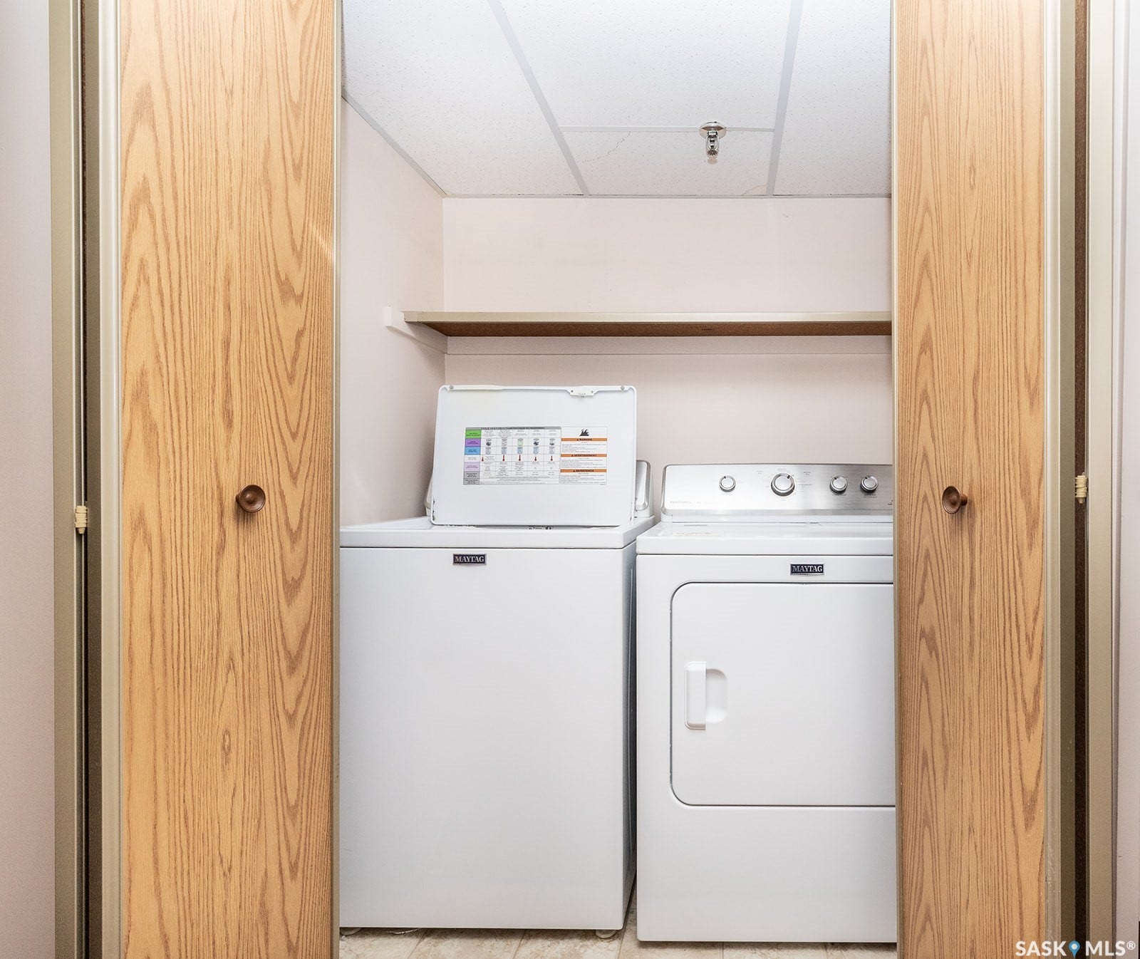 Dedicated laundry area with a top-load washer and front-load dryer
