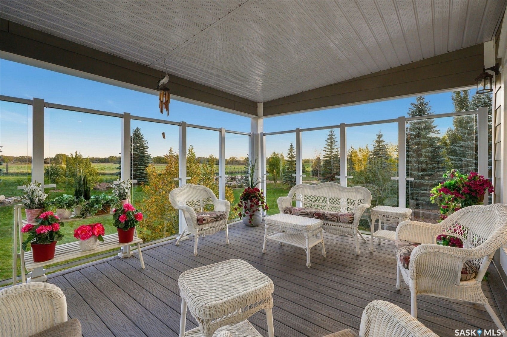 Covered balcony featuring a wood-finish floor and a glass railing system