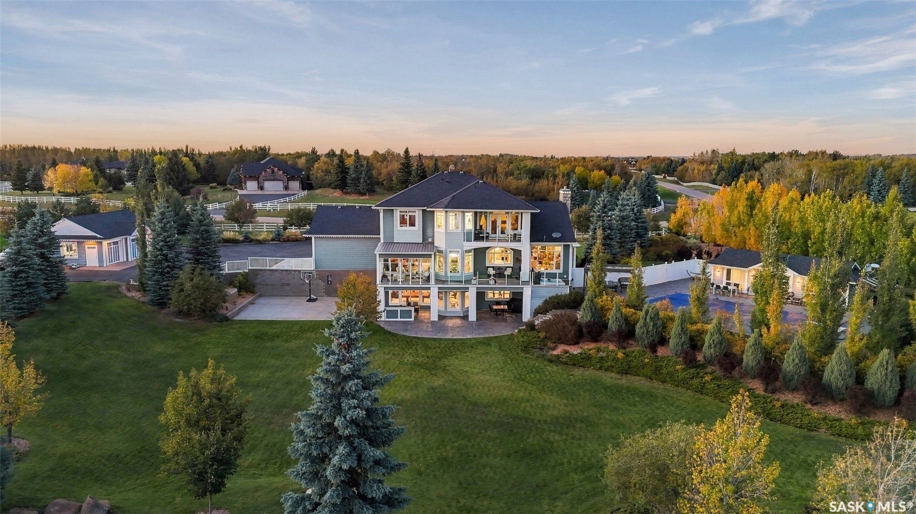 Two-story residence with multiple balconies and a lower-level patio