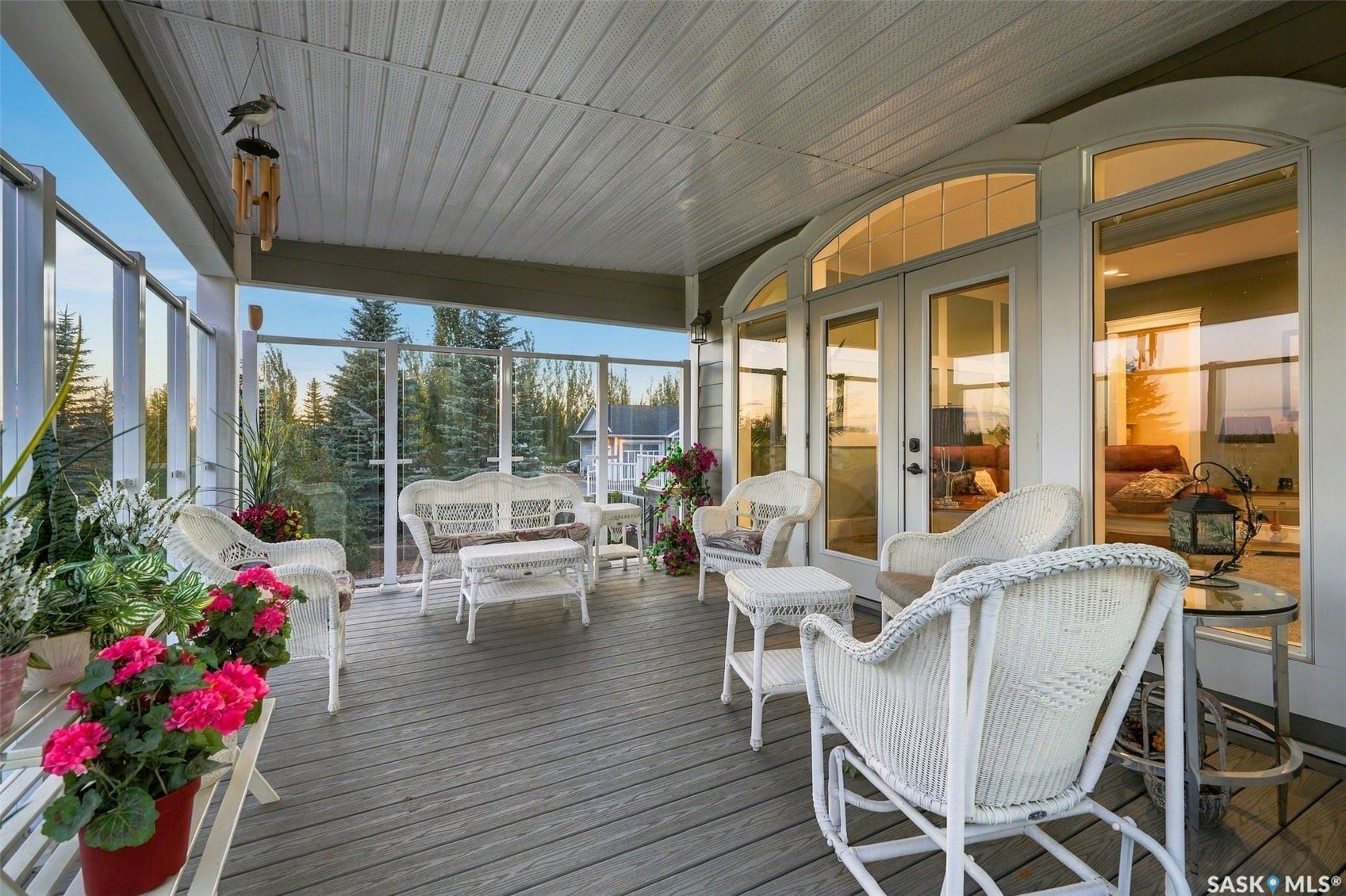 Covered balcony featuring a wood-finish floor and glass panel railings
