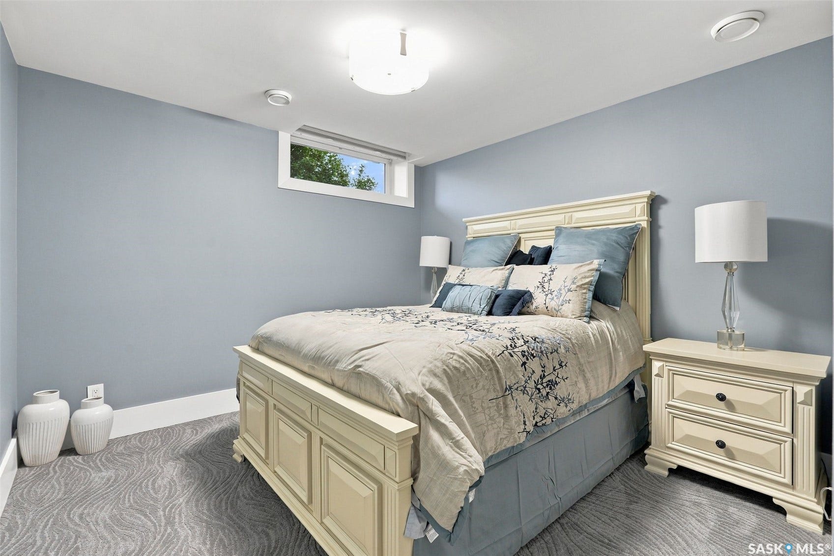 Recessed lighting, patterned carpeting, and an egress window