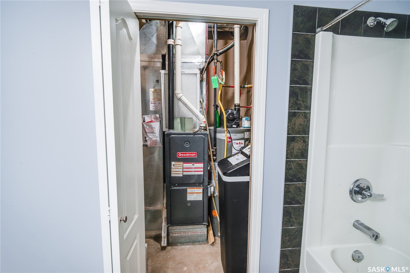 Utility closet with a furnace unit and water softener system