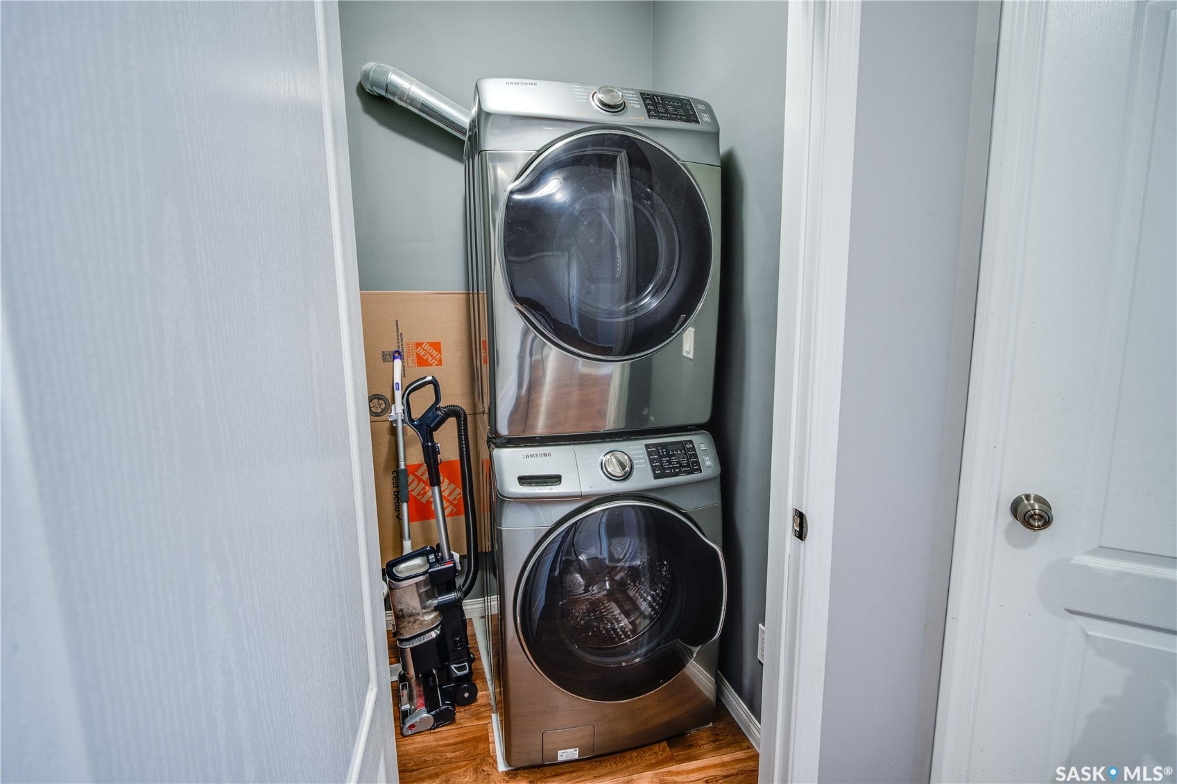 Dedicated laundry closet with stacked washer and dryer appliances