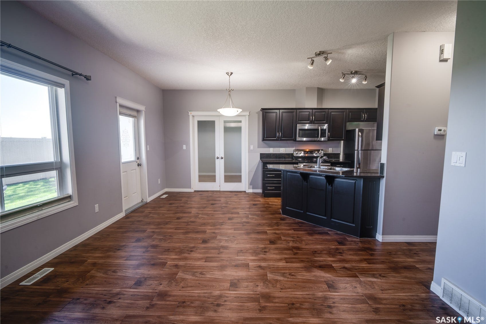 Kitchen with dark wood cabinetry and stainless steel appliances