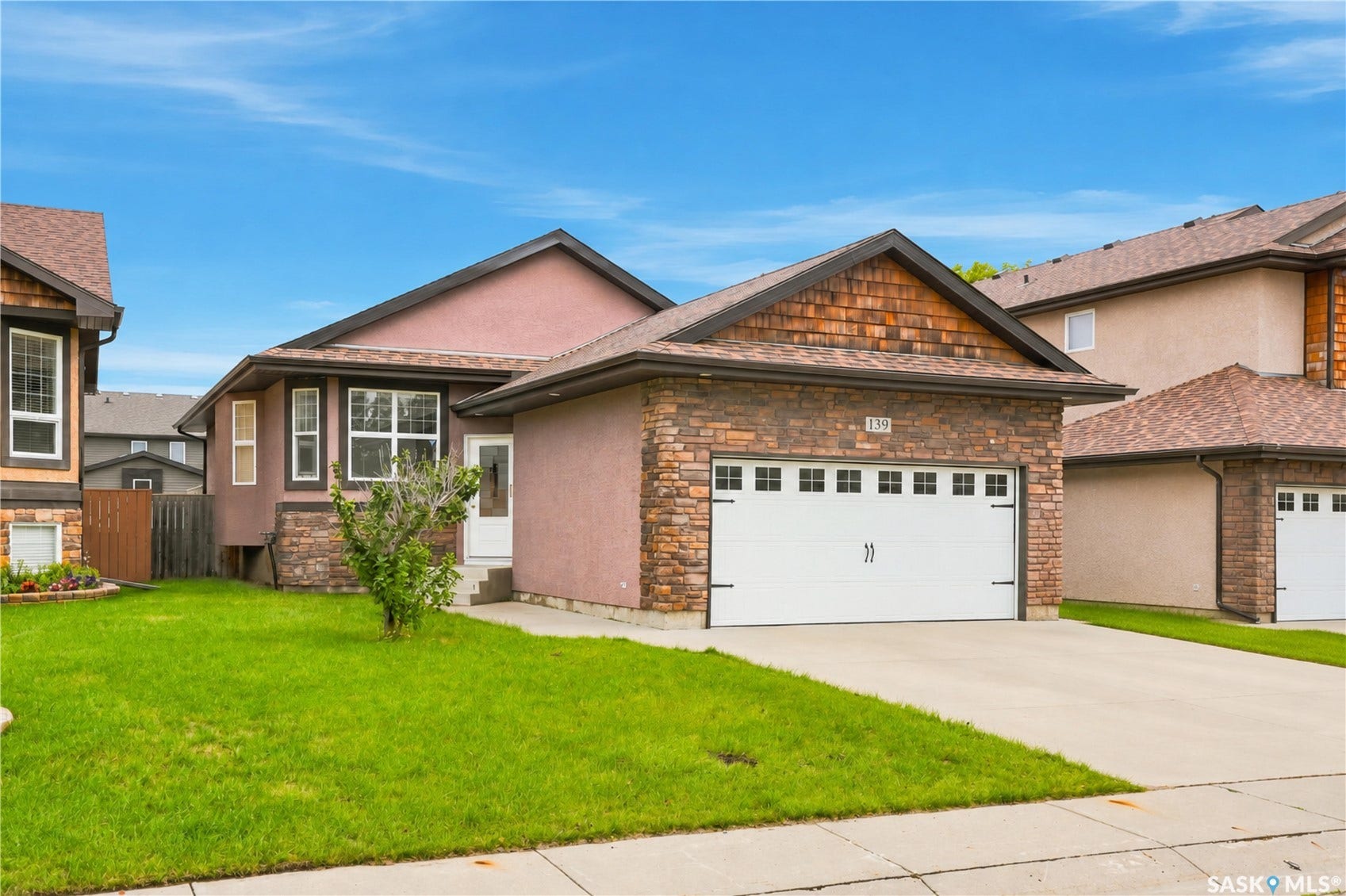 Exterior featuring a single-car garage, concrete driveway, and a combination of stucco and stone finishes